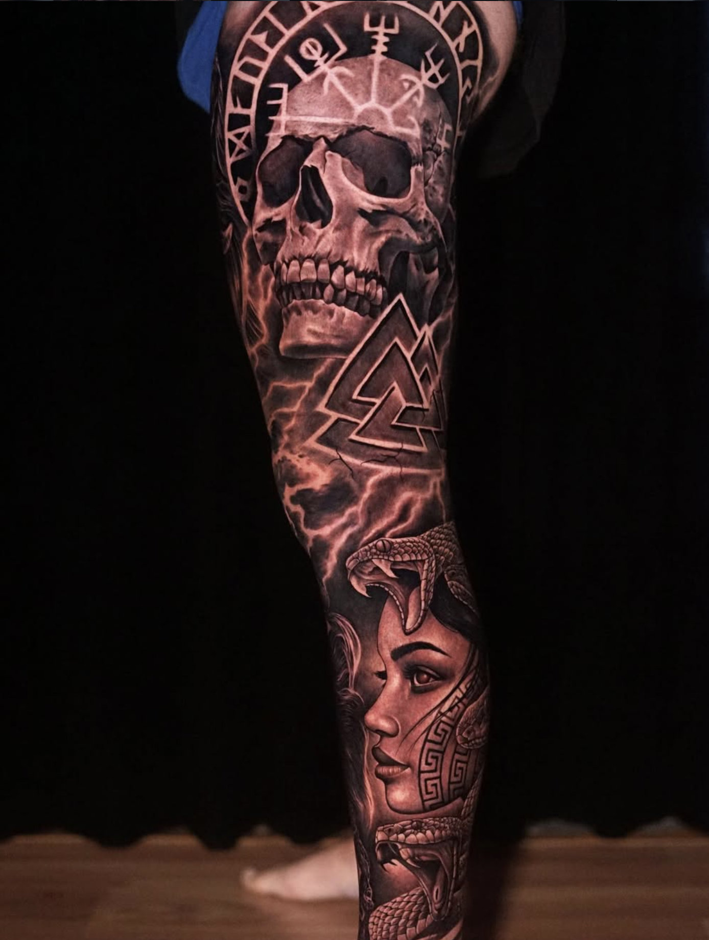 Full black and grey leg tattoo by a Love Gun artist