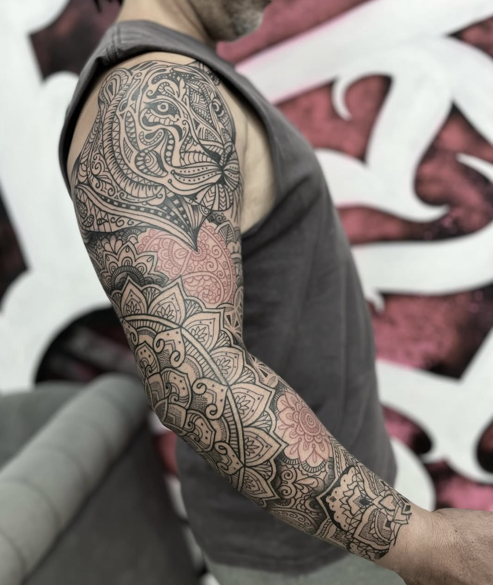 Ornamental mandala sleeve tattoo by a Love Gun artist