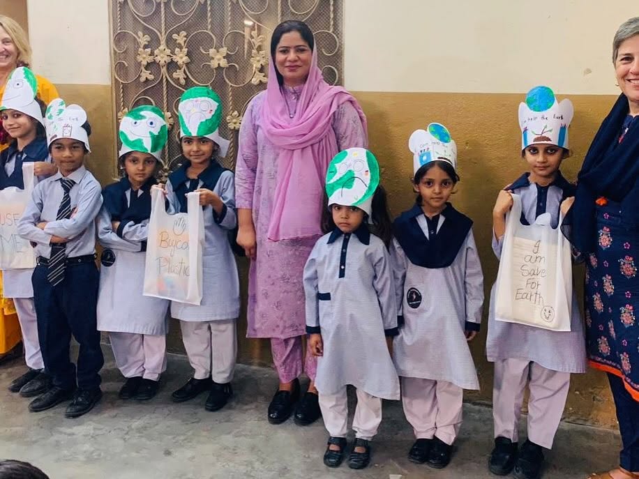 Schoolchildren with their teacher at a Zephaniah education program in Pakistan
