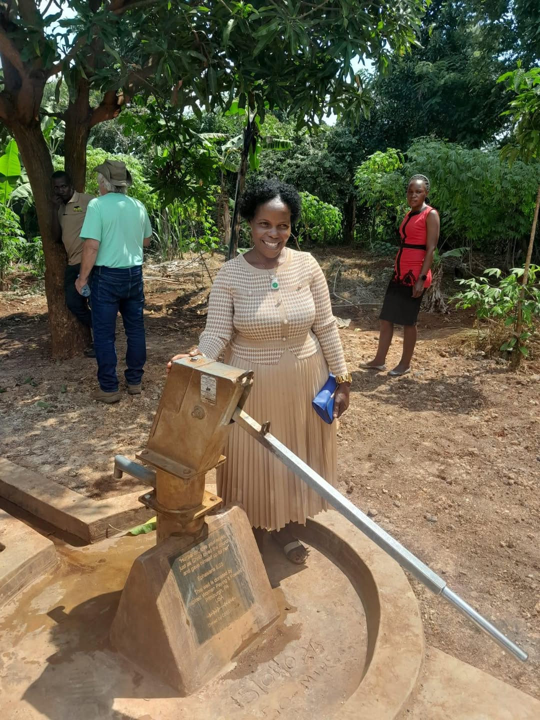 Women filling water containers at a well funded through Last Mile 4D in Kenya