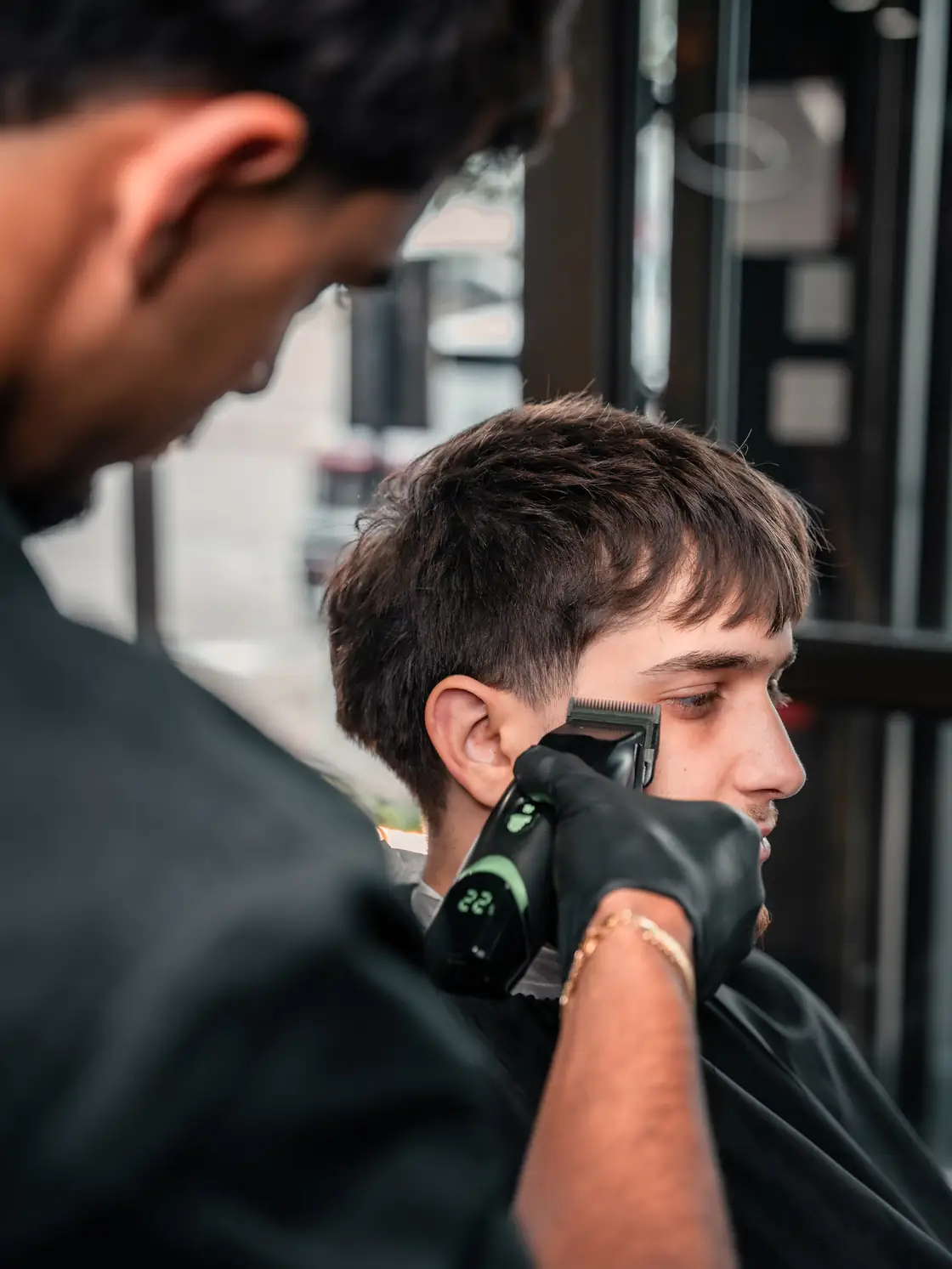 A barber lining up a client&rsquo;s beard at FahadFadez Barbershop in Mississauga