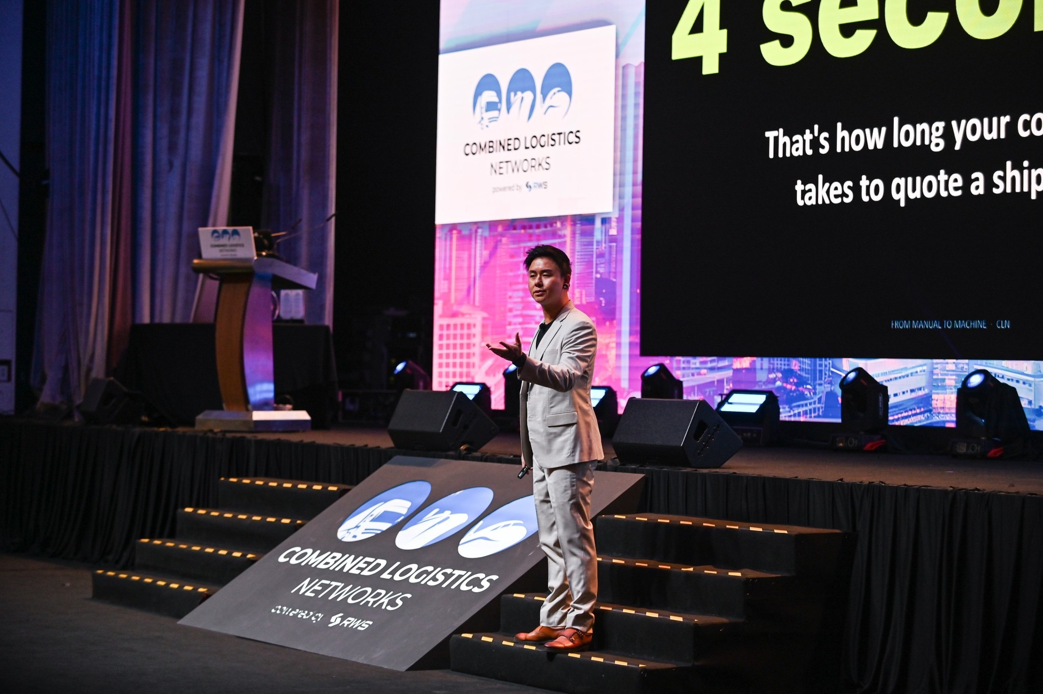 Miah on stage at a conference