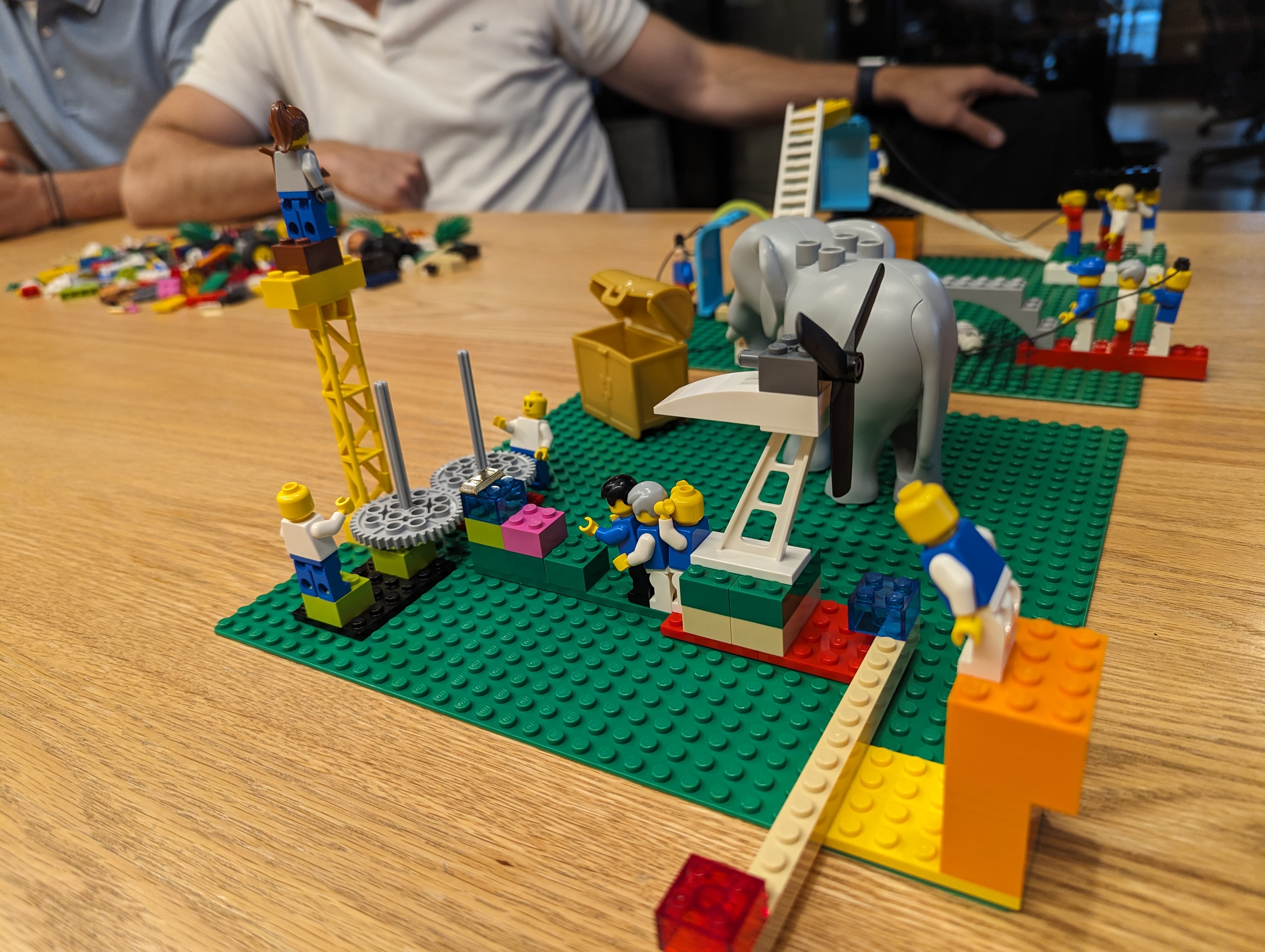 Team building physical models with LEGO bricks representing their ideas