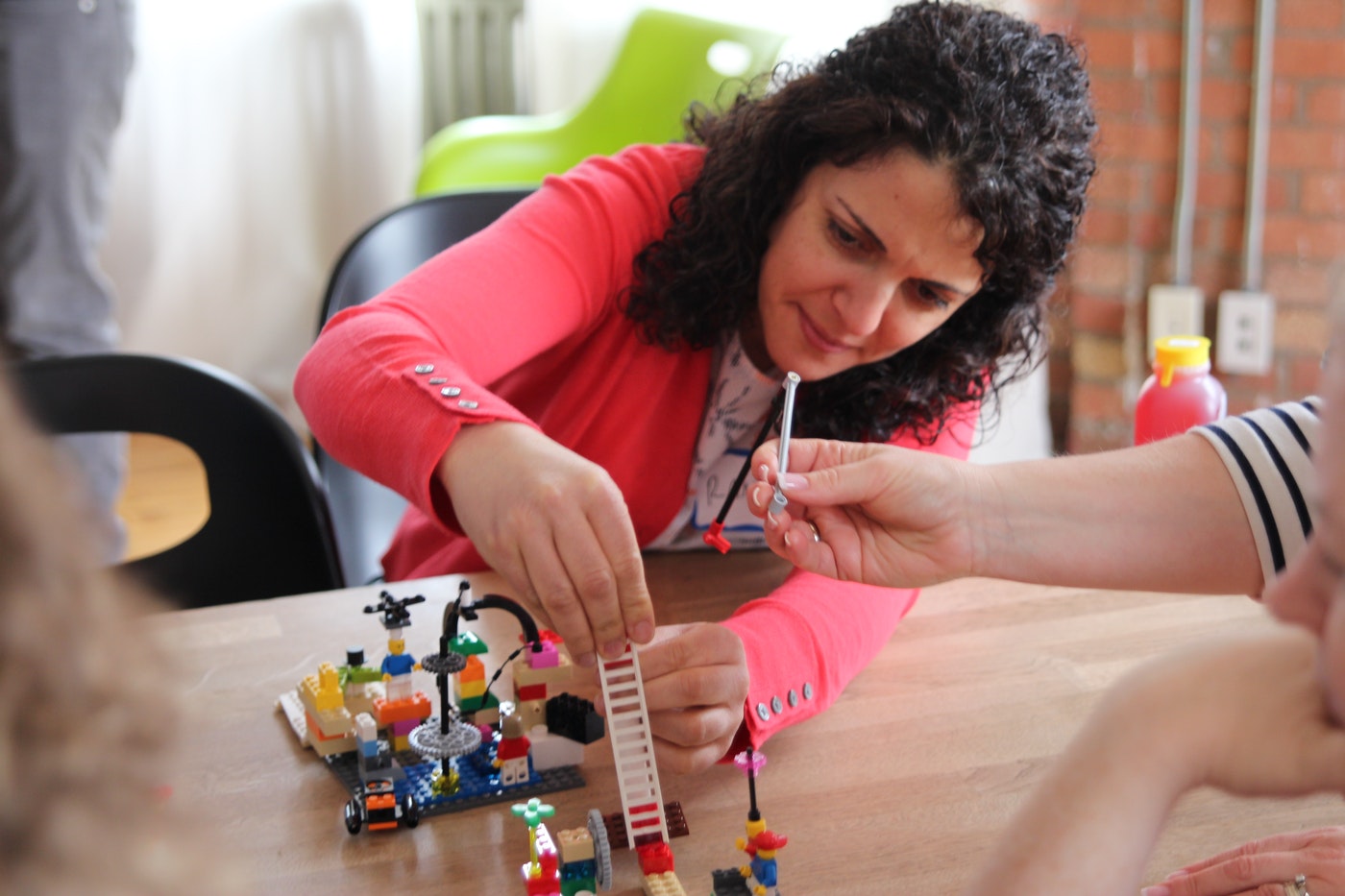 Participant building with LEGO bricks during a Pressure-Proof Leadership workshop