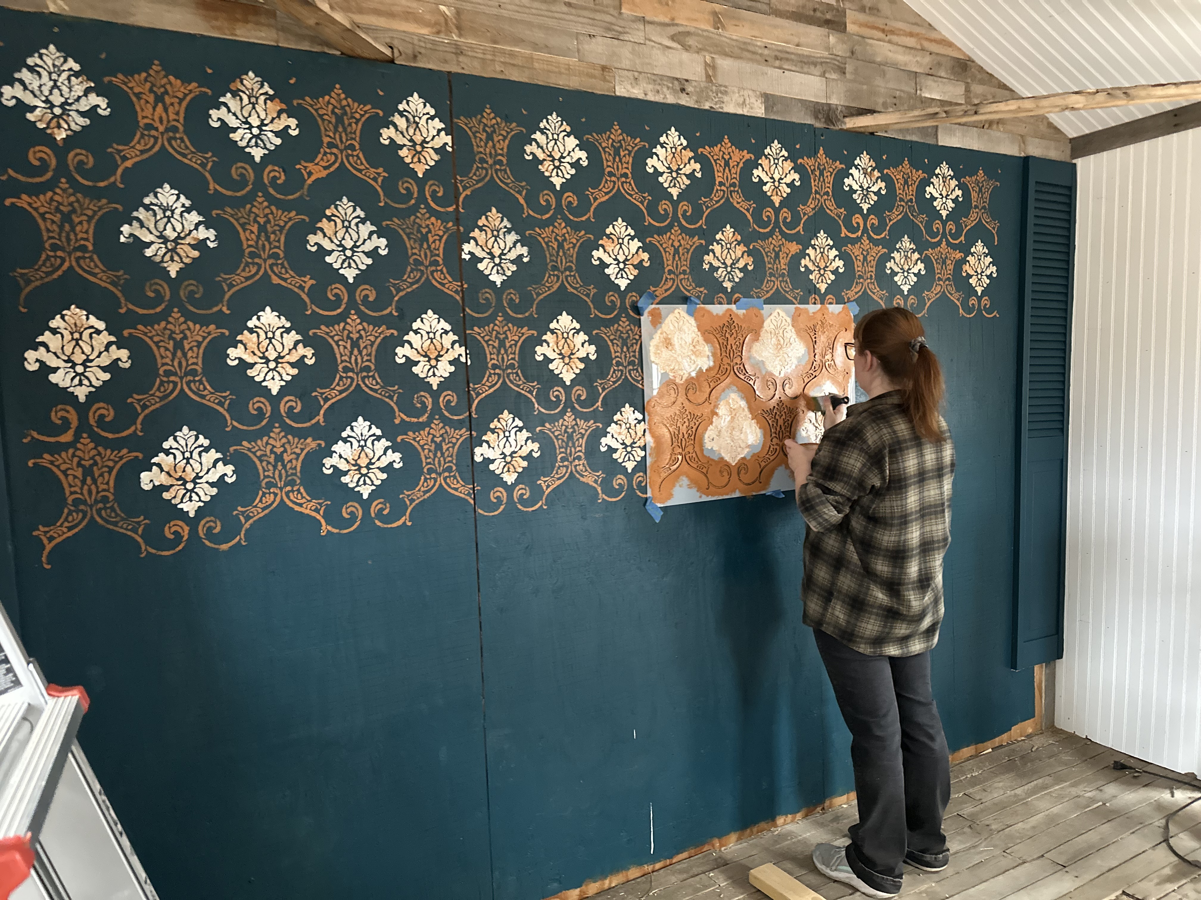 Painting the stencil on the back wall of the chicken palace Painting the stencil on the back wall of the chicken palace