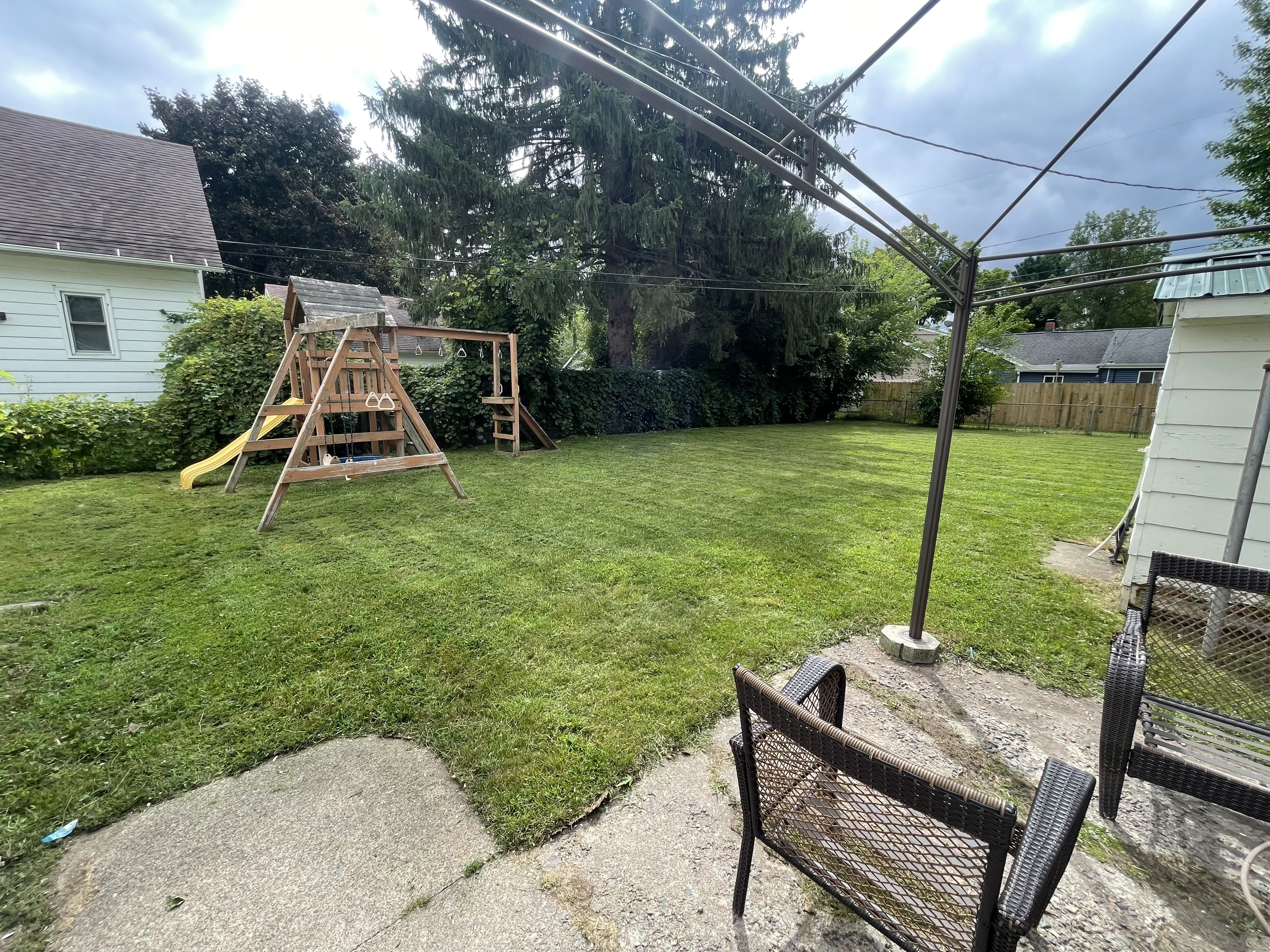 Freshly mowed backyard lawn with clean edges after professional lawn service by Mr. Pigs Lawn Care.jpg