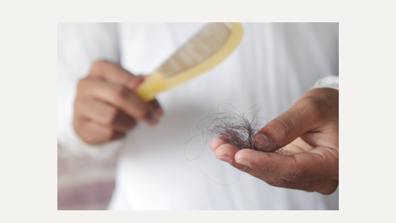 hair in brush in hand