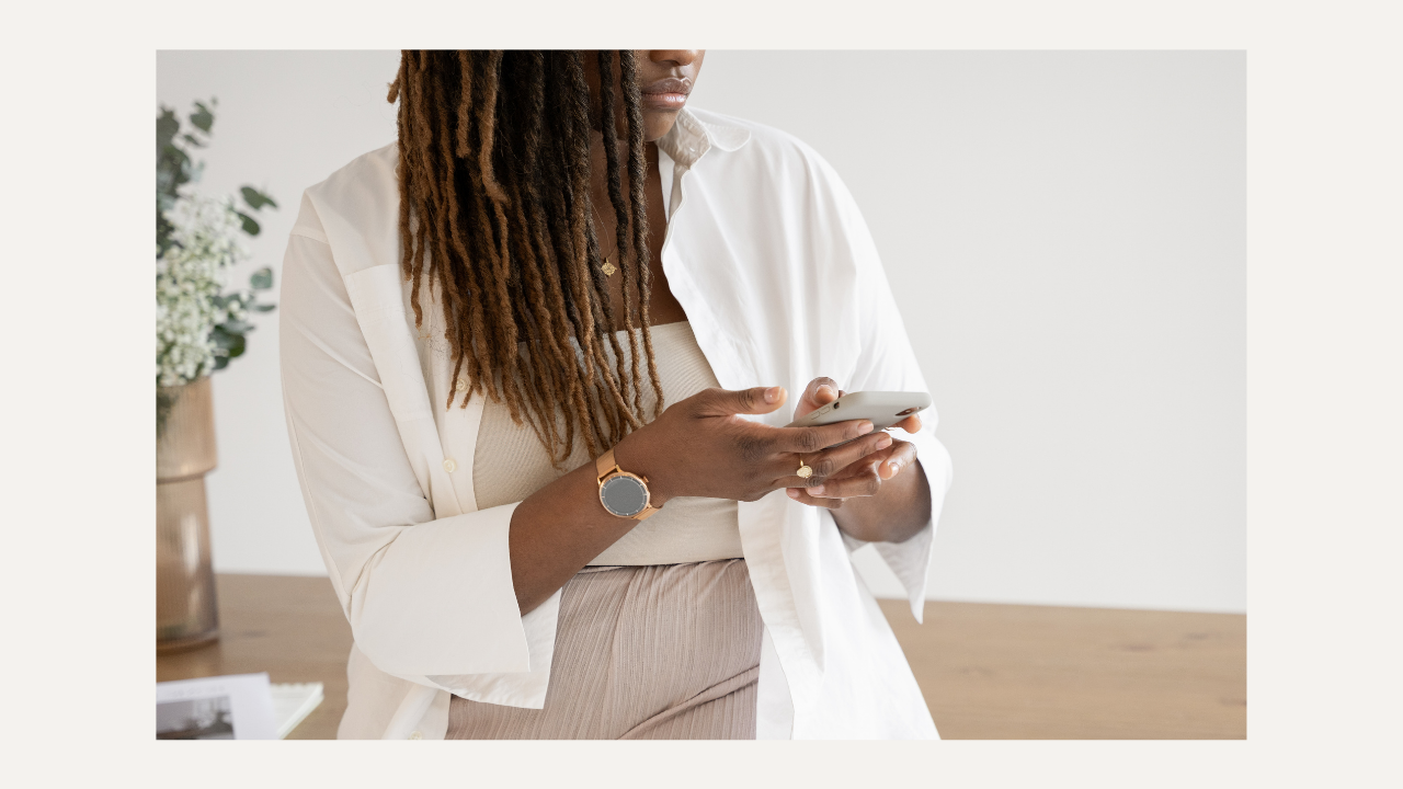 busy woman on her phone in neutral clothes