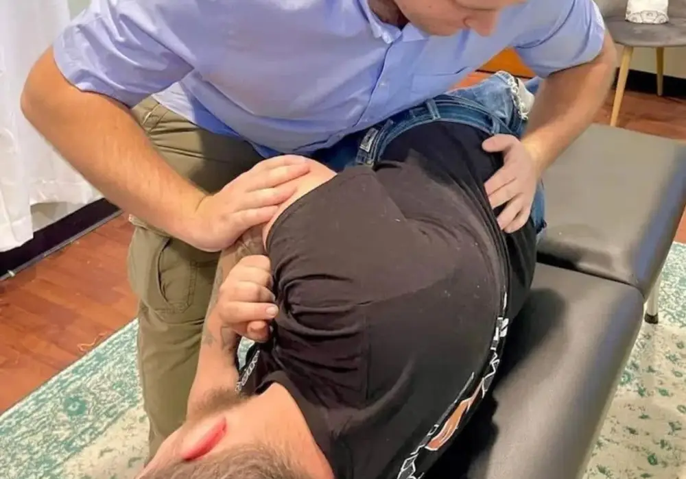 Dr. Tyler Randolph performing a chiropractic adjustment