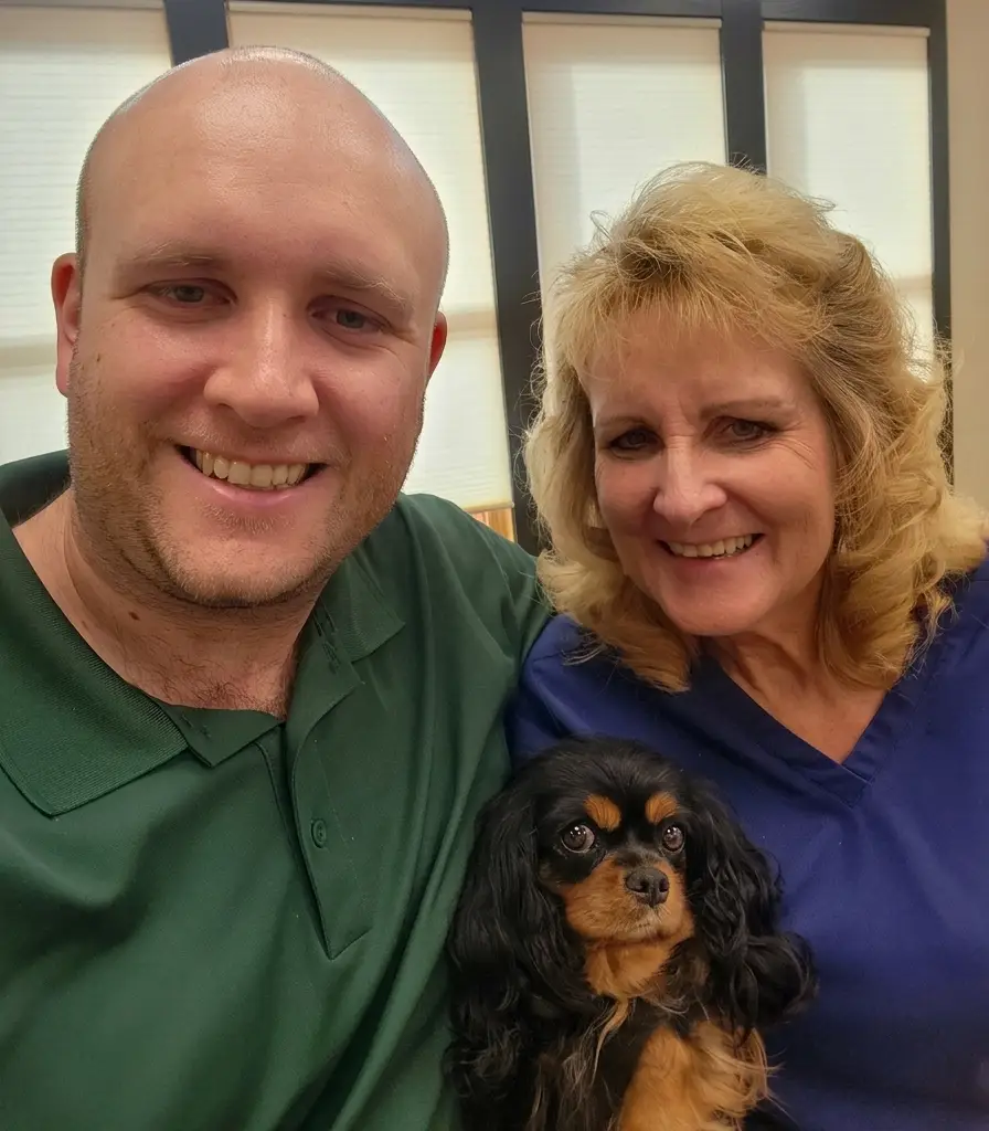 Dr. Tyler and Nancy in a group photo with their dog Thea