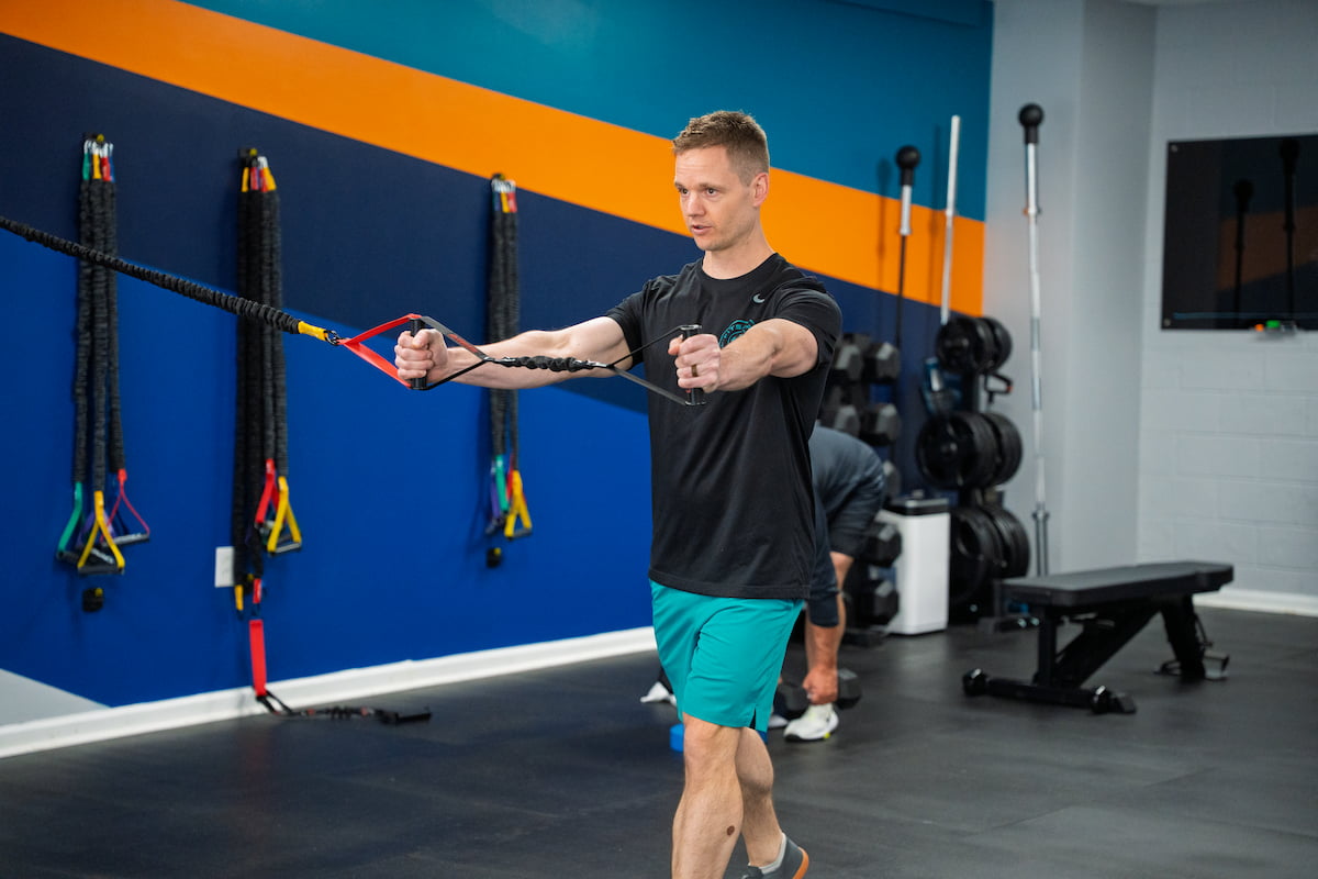 Corey Nielsen demonstrating resistance band exercise at Fitspire Personal Training