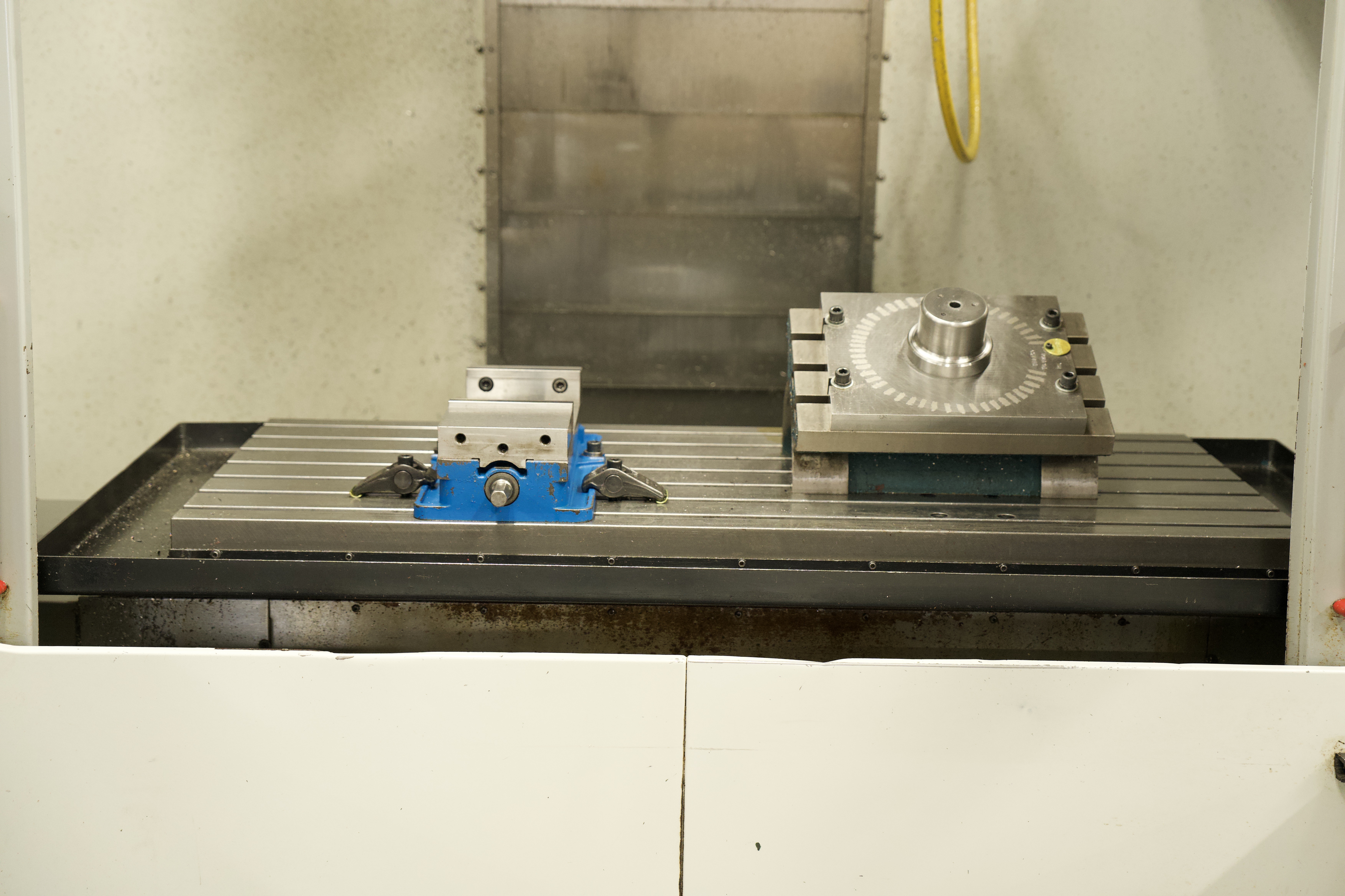 CNC milling a metal part at Manor Tool