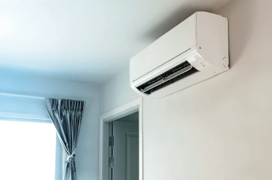 Modern wall-mounted split aircon unit in a bright room