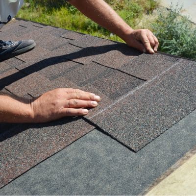 Roof Contractor aligning shingles