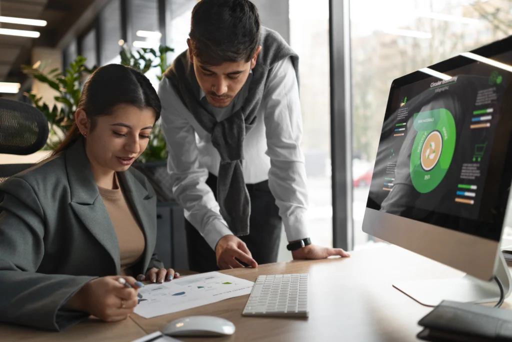 Business professionals analyzing marketing performance graphs in office - TSG Group NY