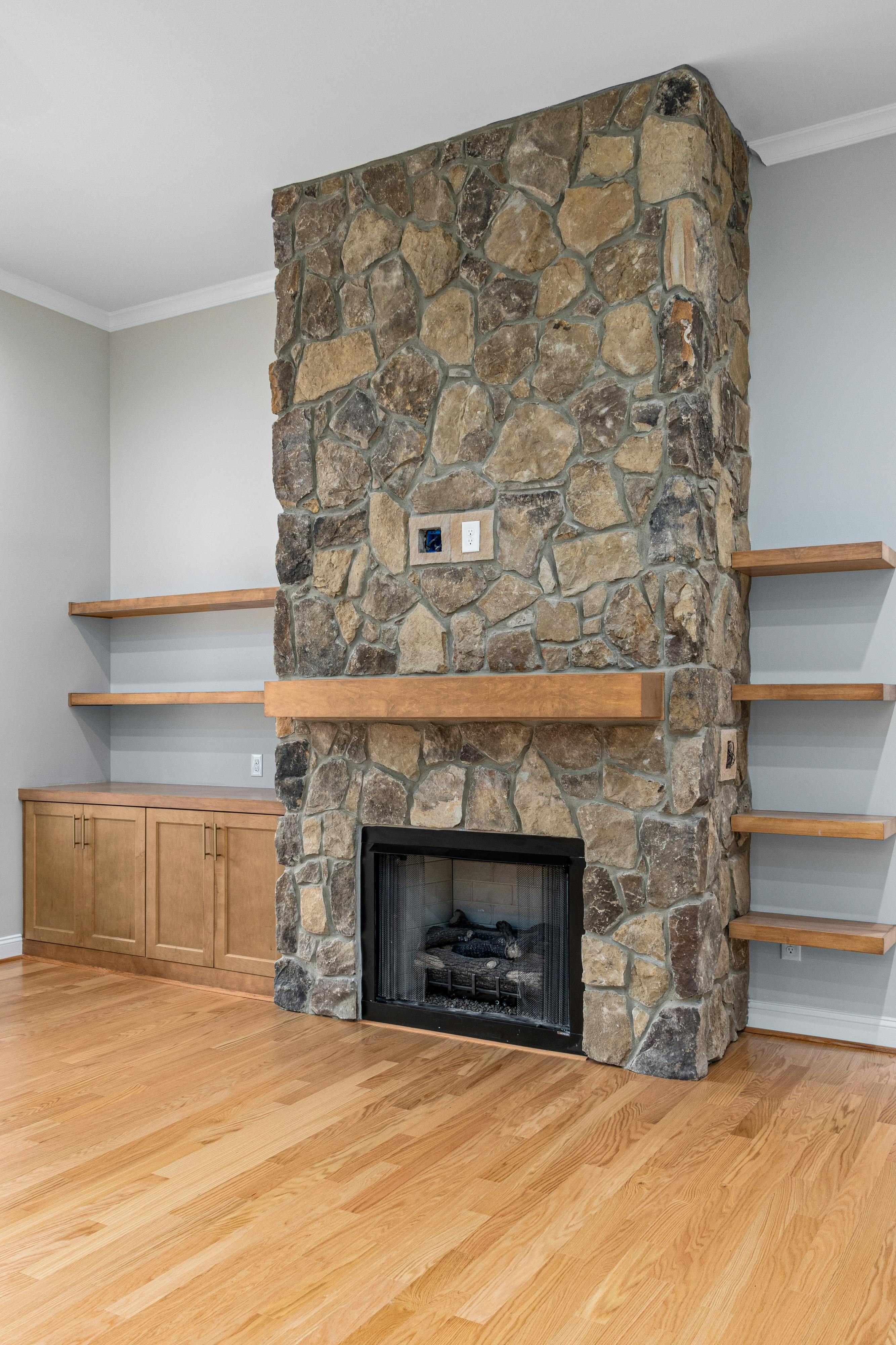 Stone fireplace surround in a transitional living room