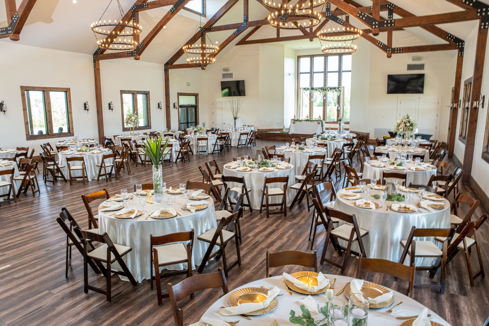 Reception tables set beneath the chandeliers in the main hall