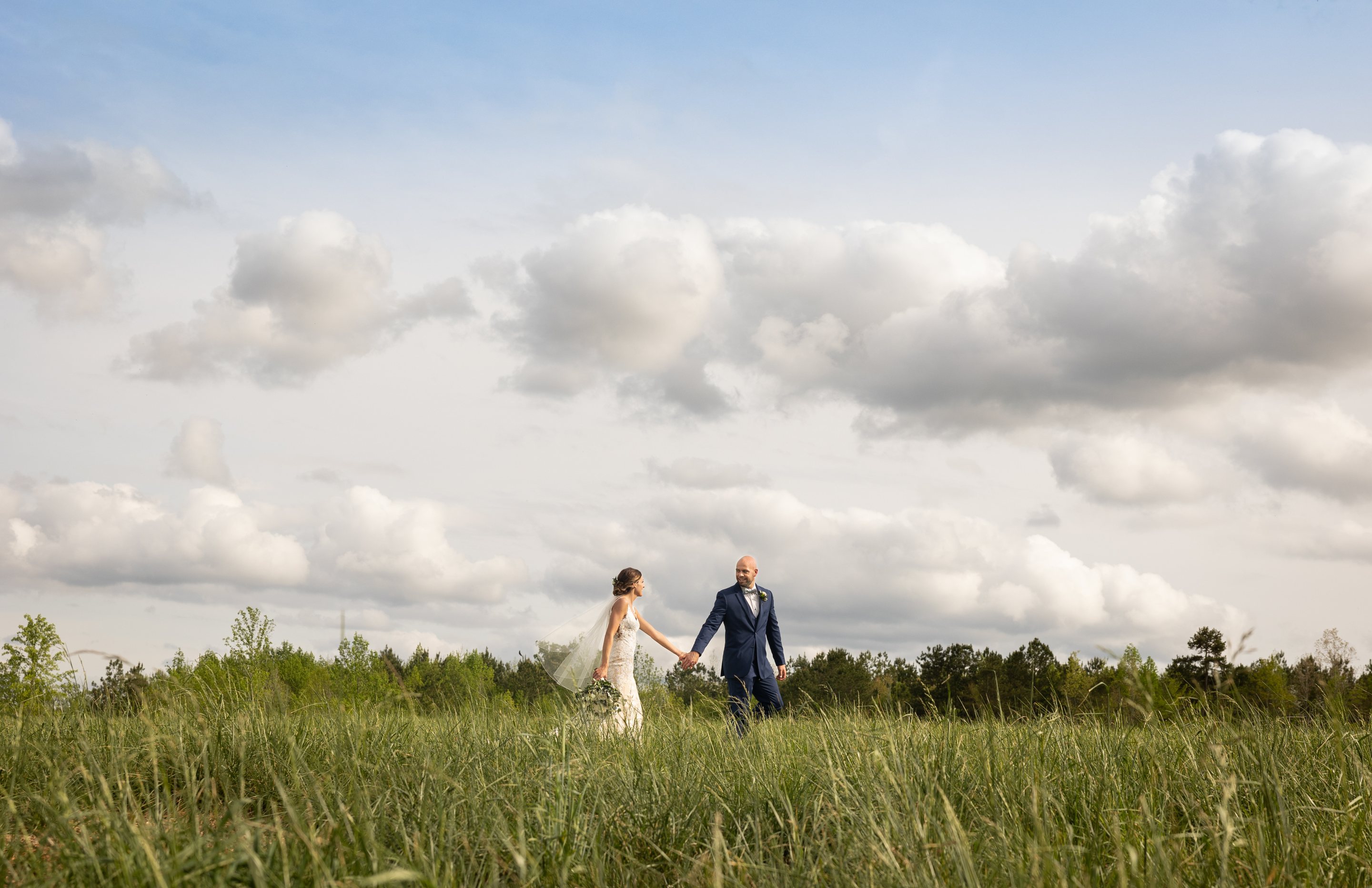A couple walking through the meadow at MeadowView Events
