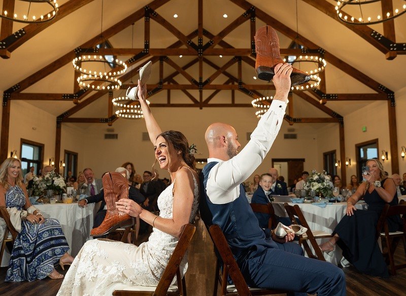 A couple raising their boots during the reception