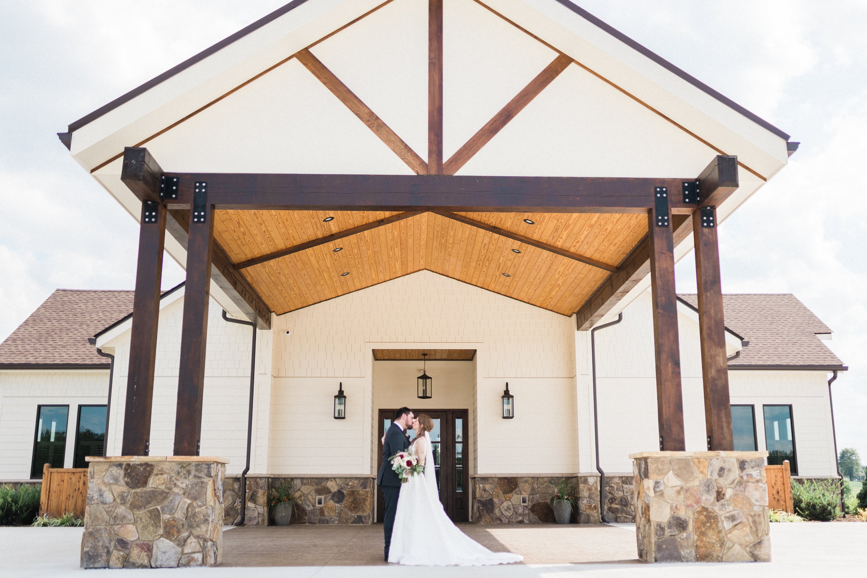 A couple beneath the covered entry at MeadowView Events