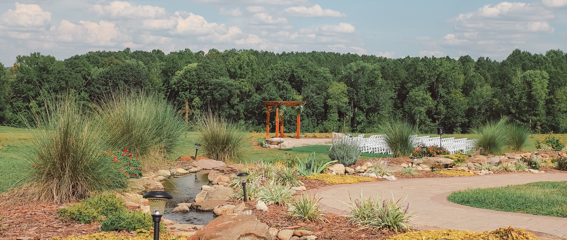 The gardens and water feature looking out toward the ceremony arbor