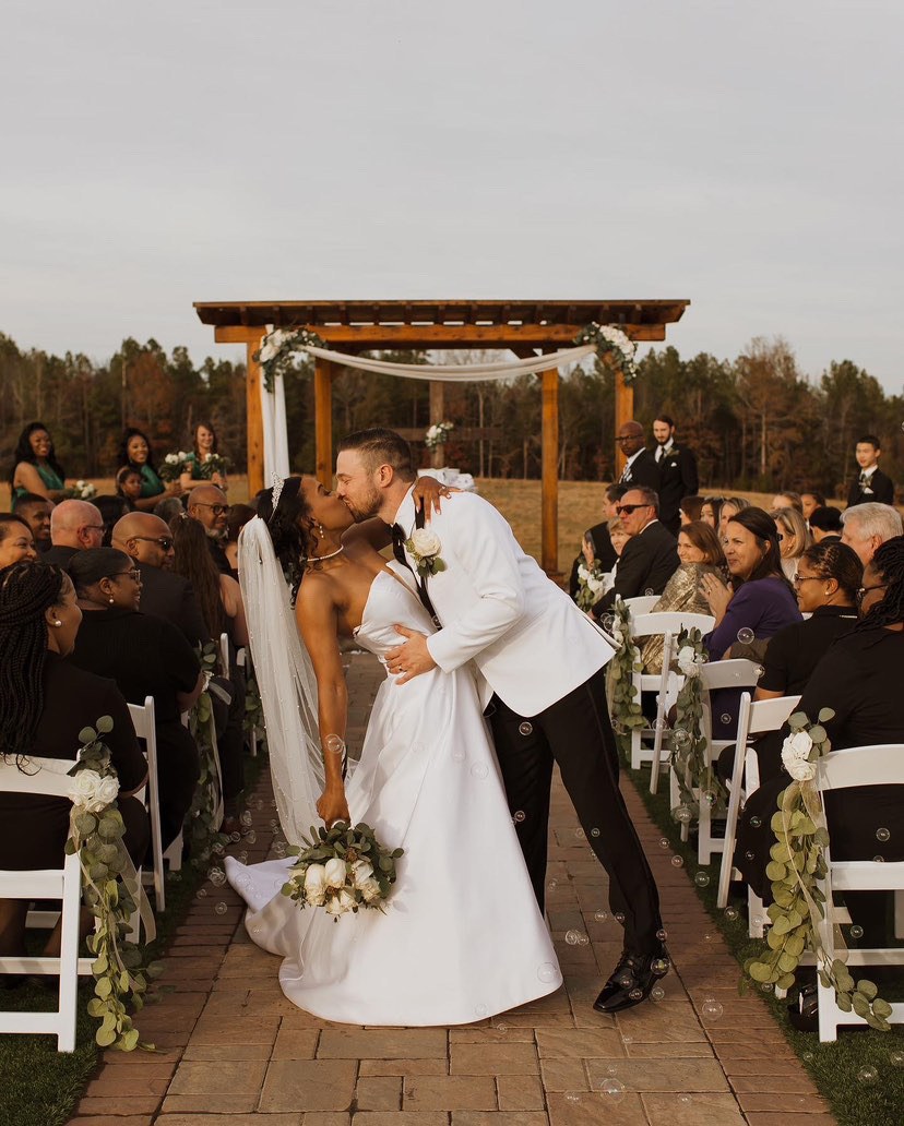 A first kiss at the outdoor ceremony
