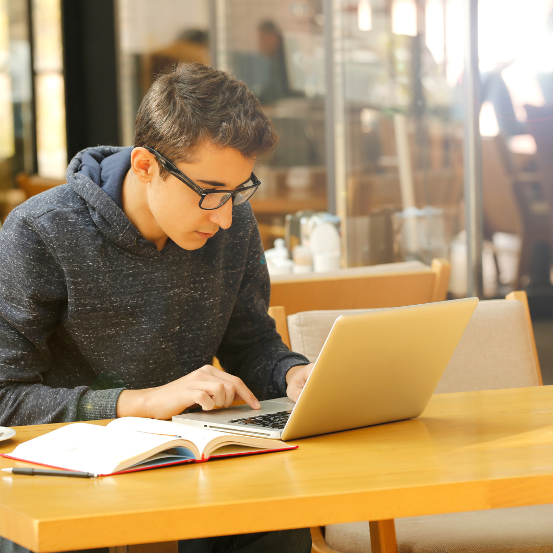 image of student working on a laptop