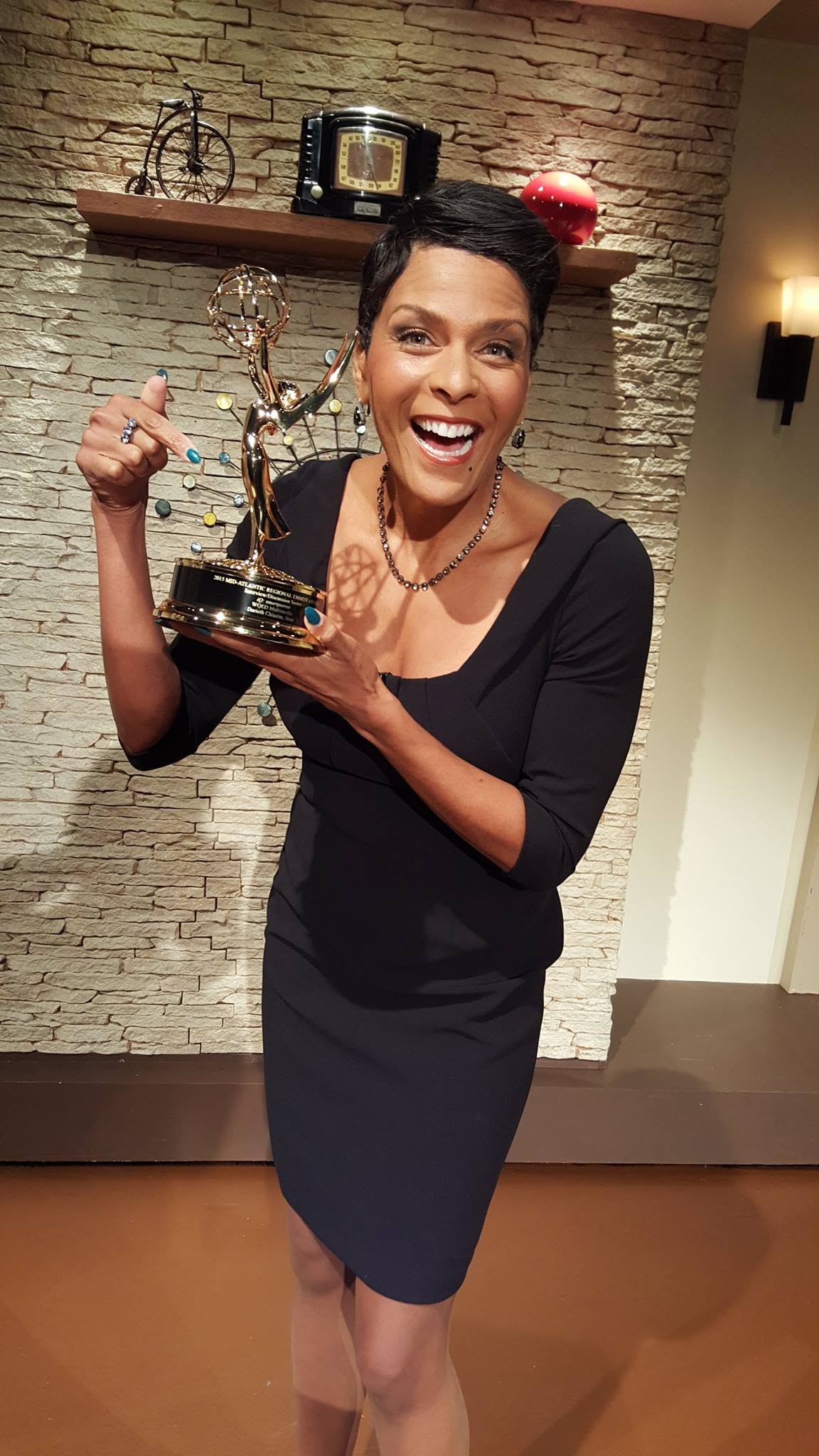 Darieth Chisolm holding her Emmy Award