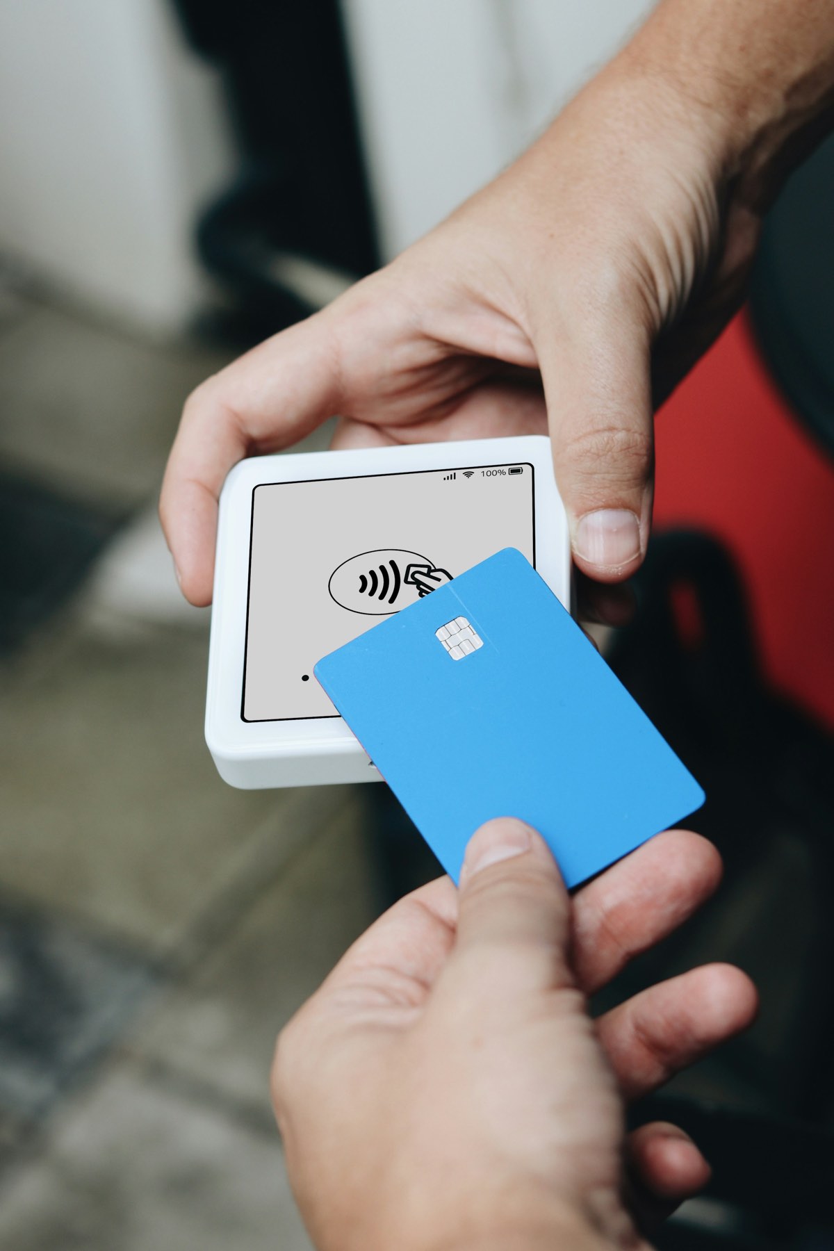 A customer pays with a card at the counter
