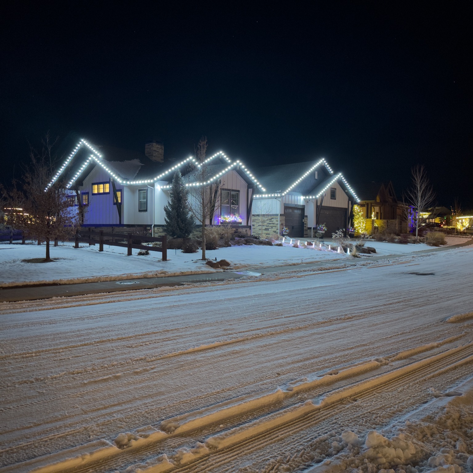 Bright cool white Christmas lights installation on Fort Collins home using commercial-grade C9 LED bulbs for modern holiday lighting