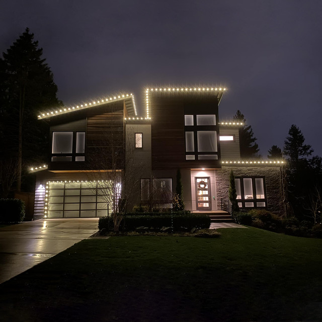 Cozy warm white roofline Christmas lights installed on a Fort Collins home