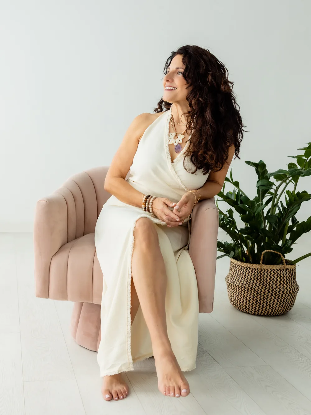 Kristina seated in a chair, looking out the window