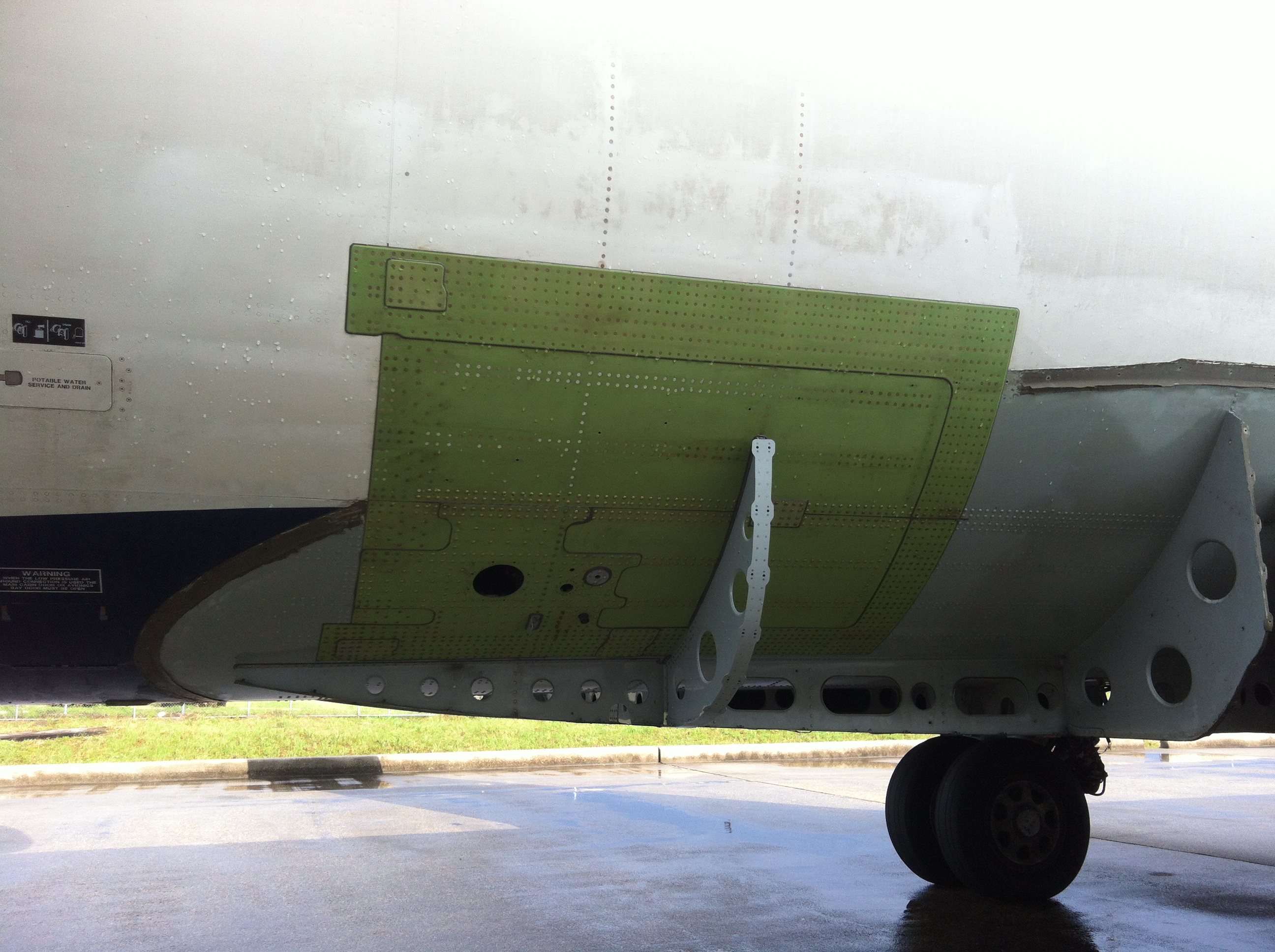 Engineers examining aircraft external panels.