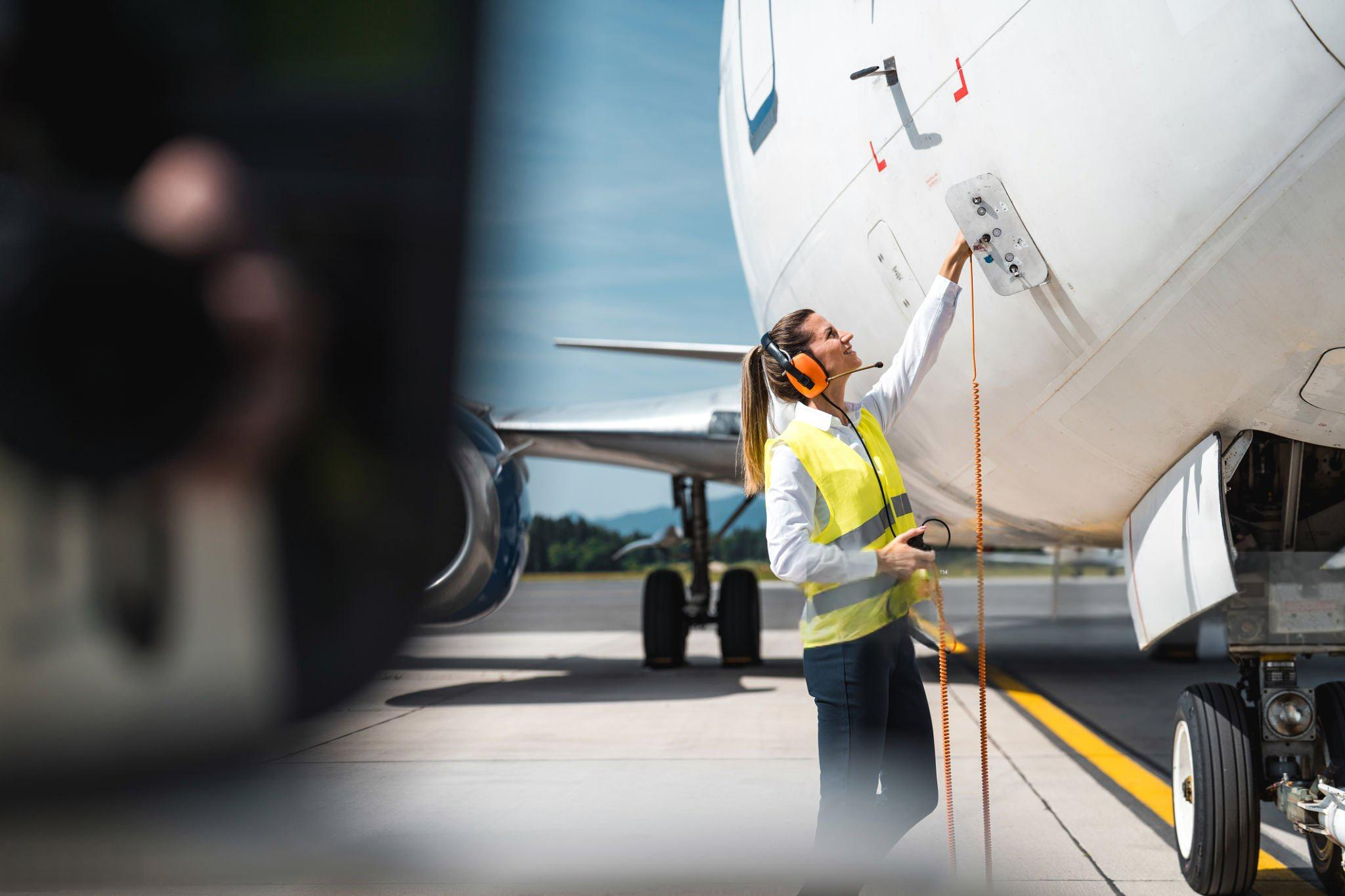 Female aviation maintenance engineer working on aircraft structures