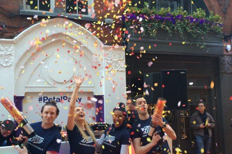 Headliner staff celebrating a confetti moment on a London street