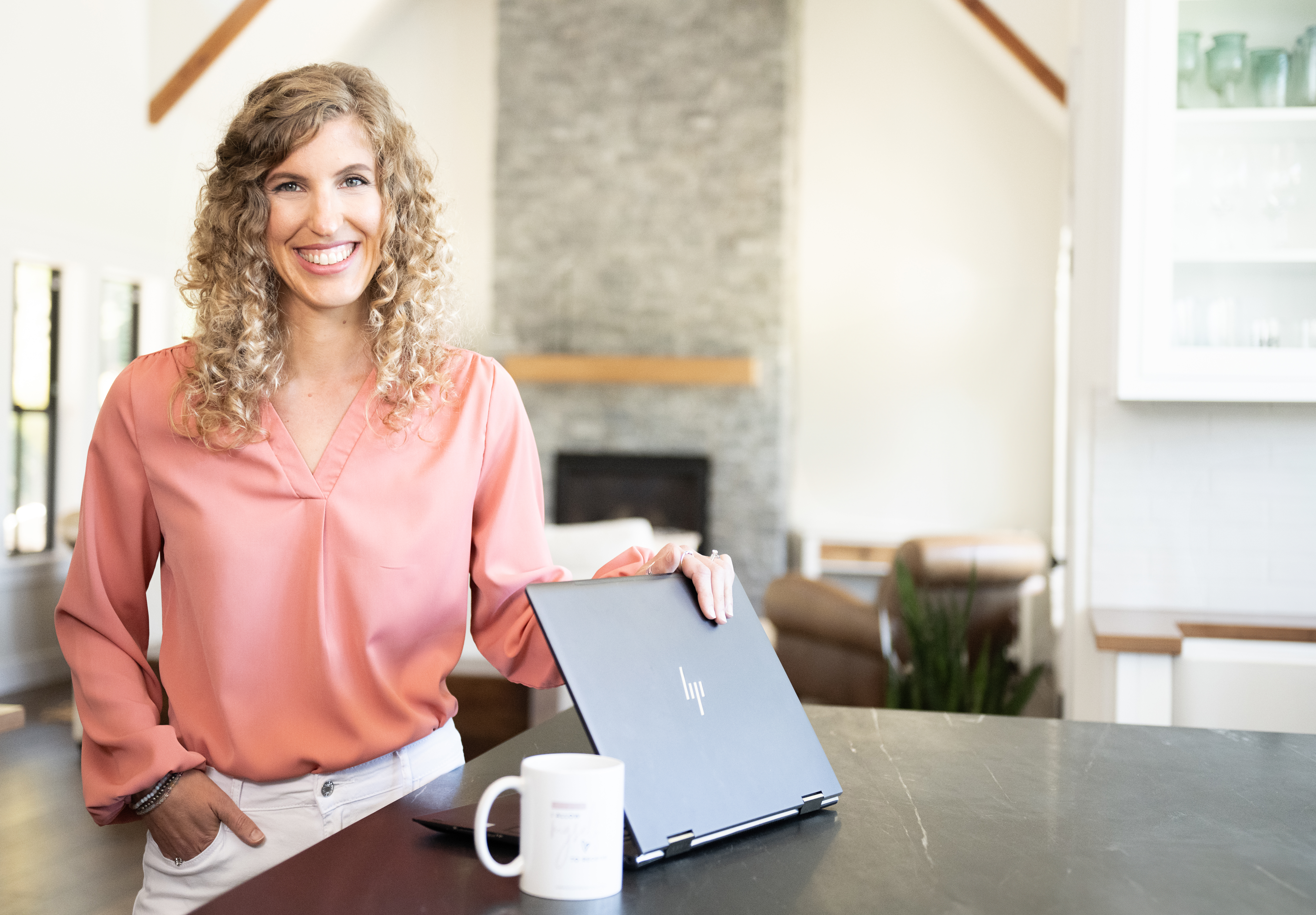Dawn Apuan opening her laptop at her desk