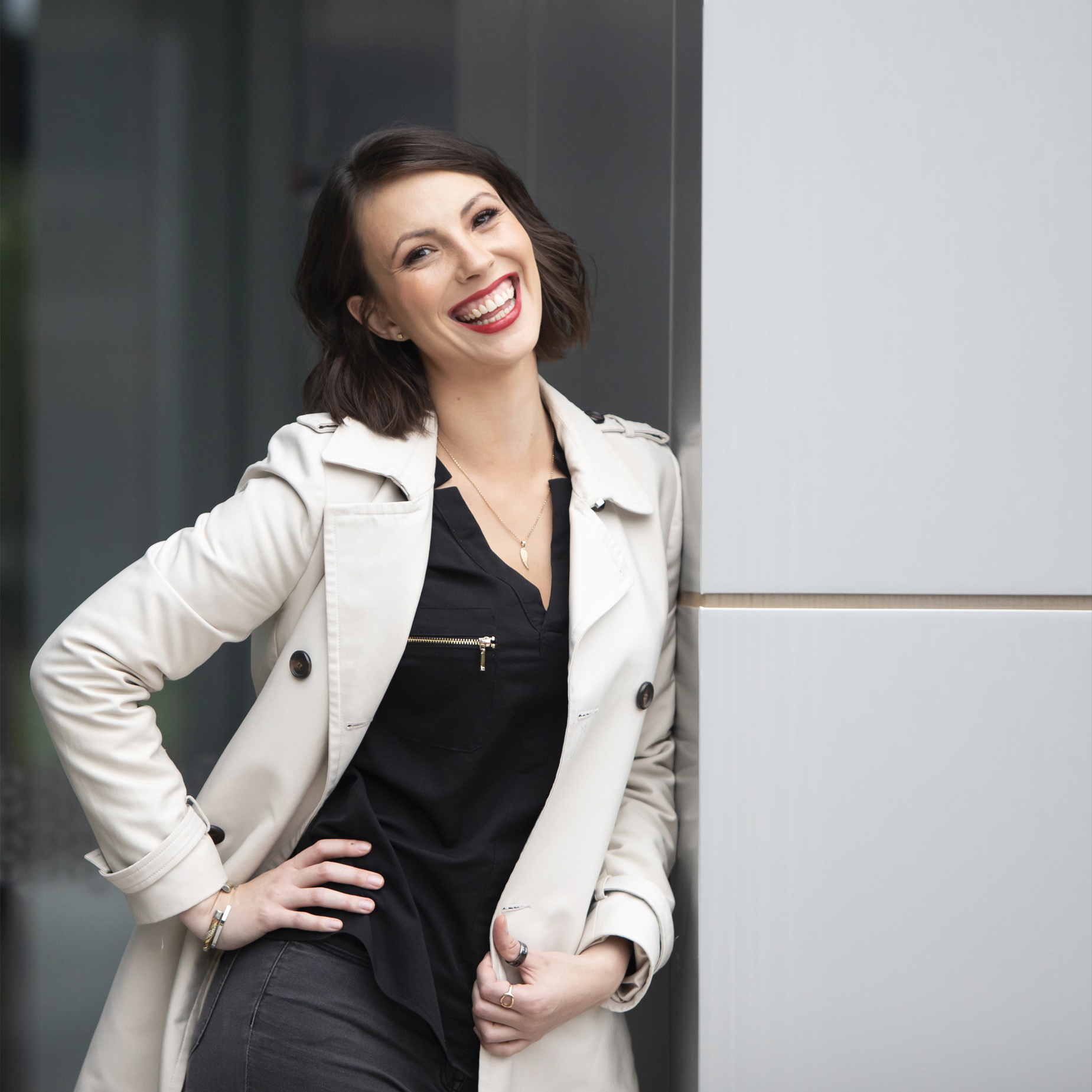 A lady leaning against a wall and wearing a trench jacket Alison McWhirter Personal branding Photography Melbourne