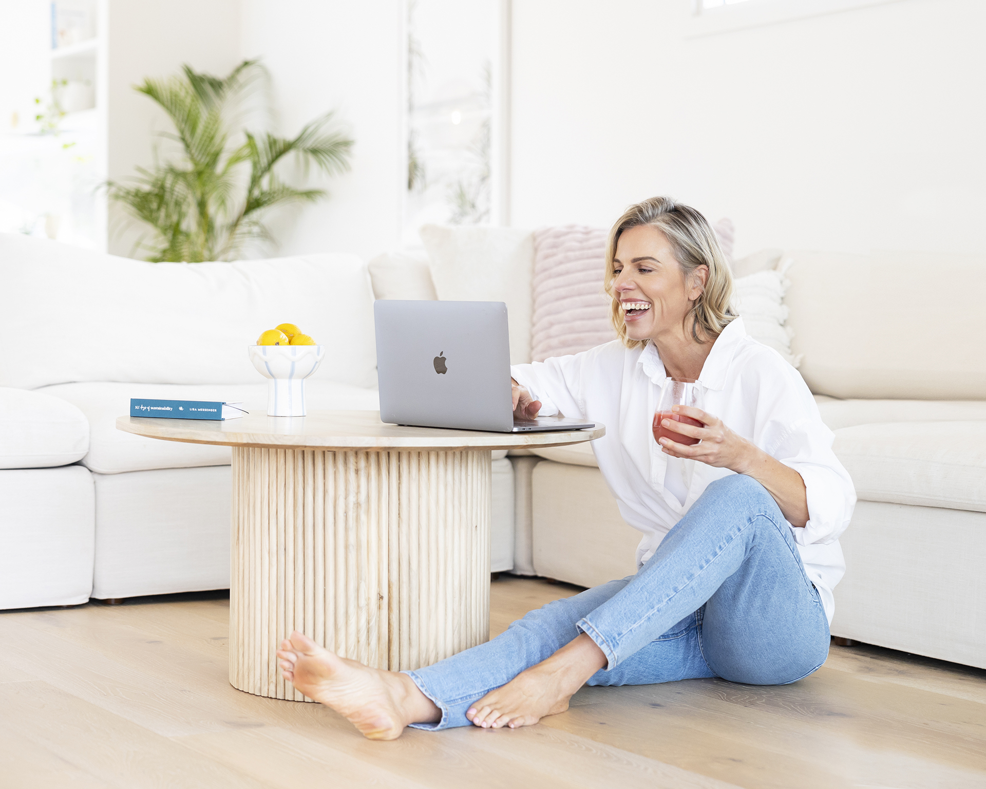 A lady sitting on the floor working on a laptopAlison McWhirter Personal branding Photography Melbourne