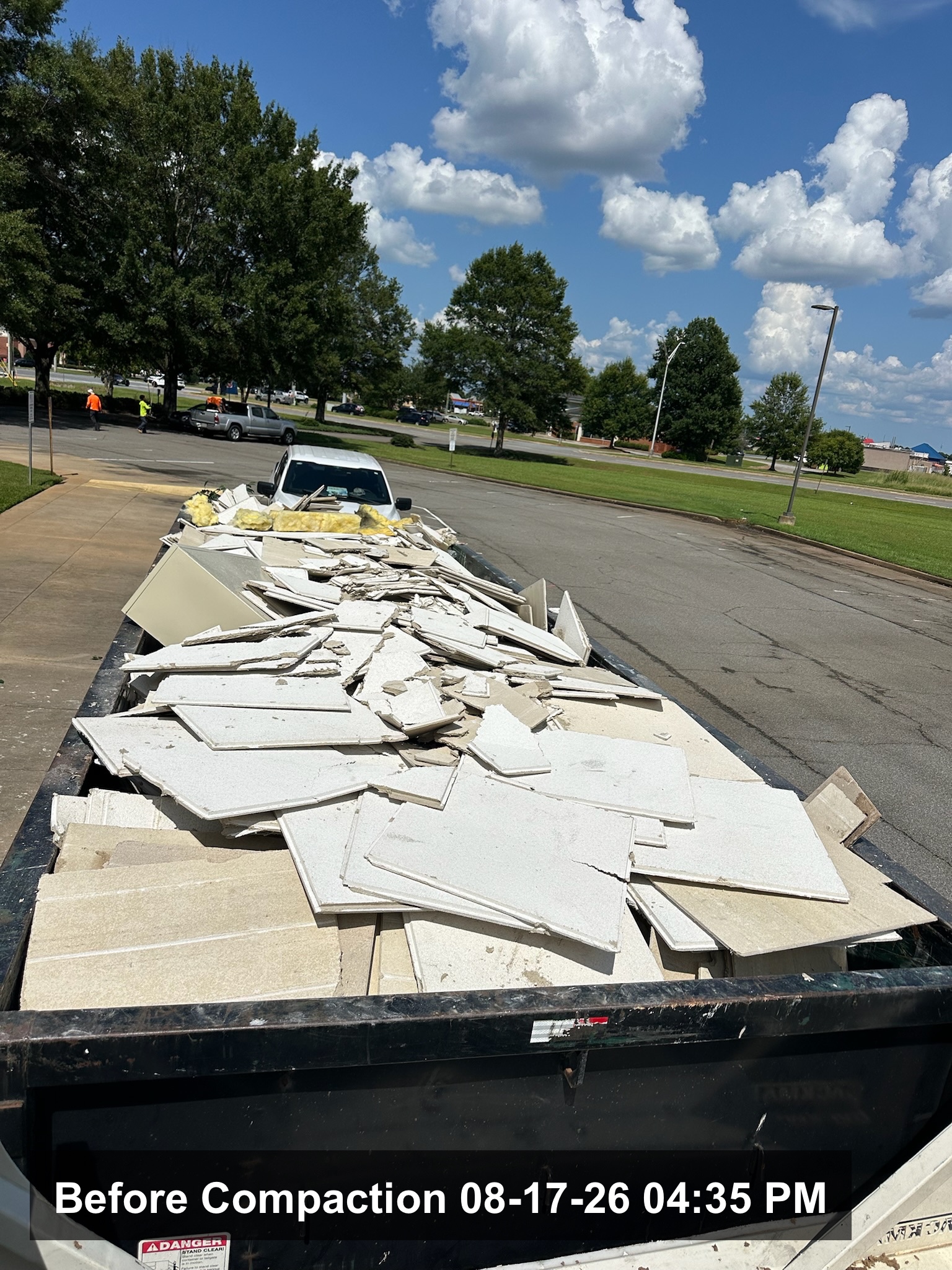 Compaction unit working a container of pallet wrap and corrugate at a transport yard on the I-16 corridor