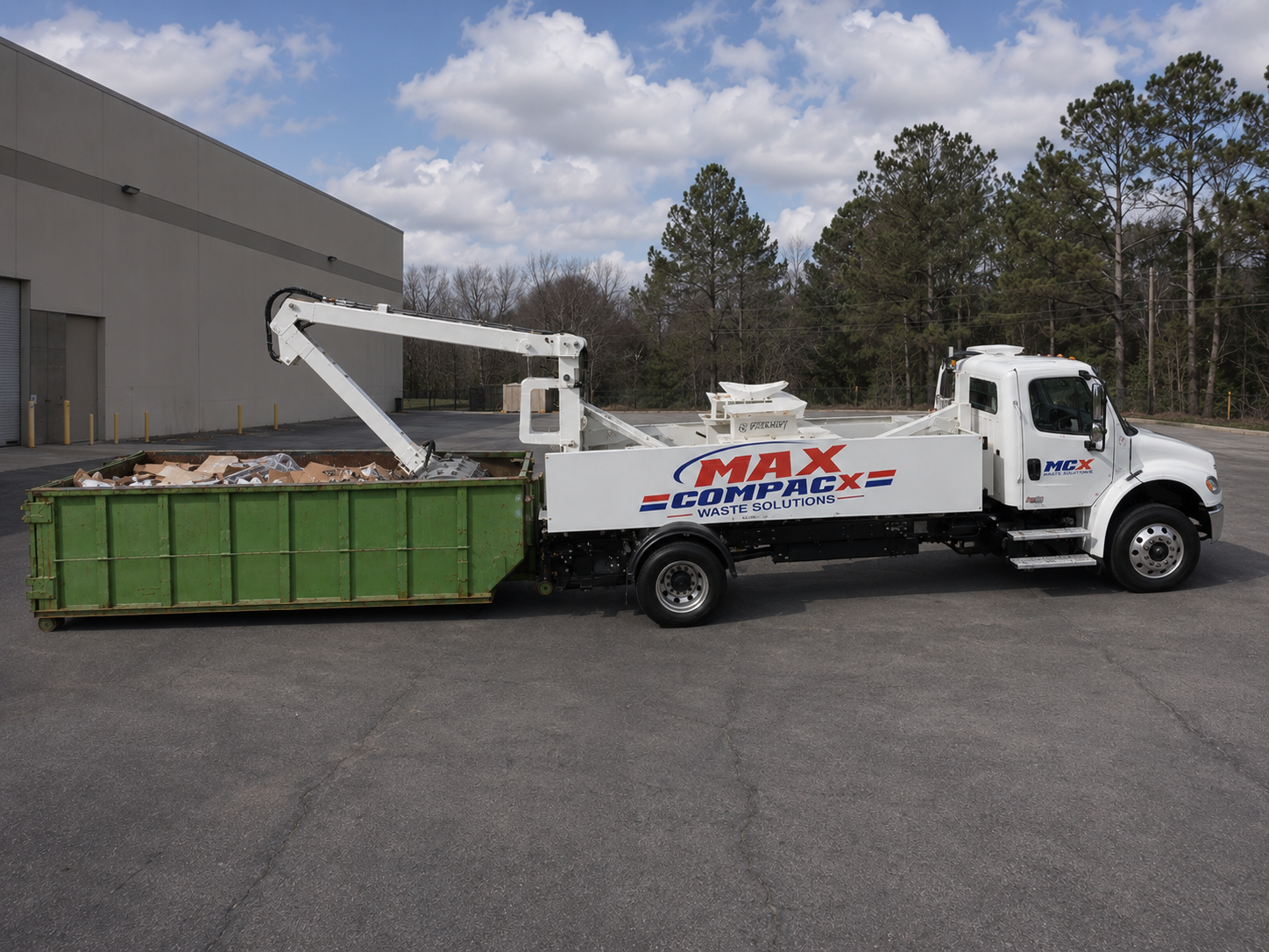 Mobile compaction truck servicing a roll-off container at a transport yard on the I-16 corridor