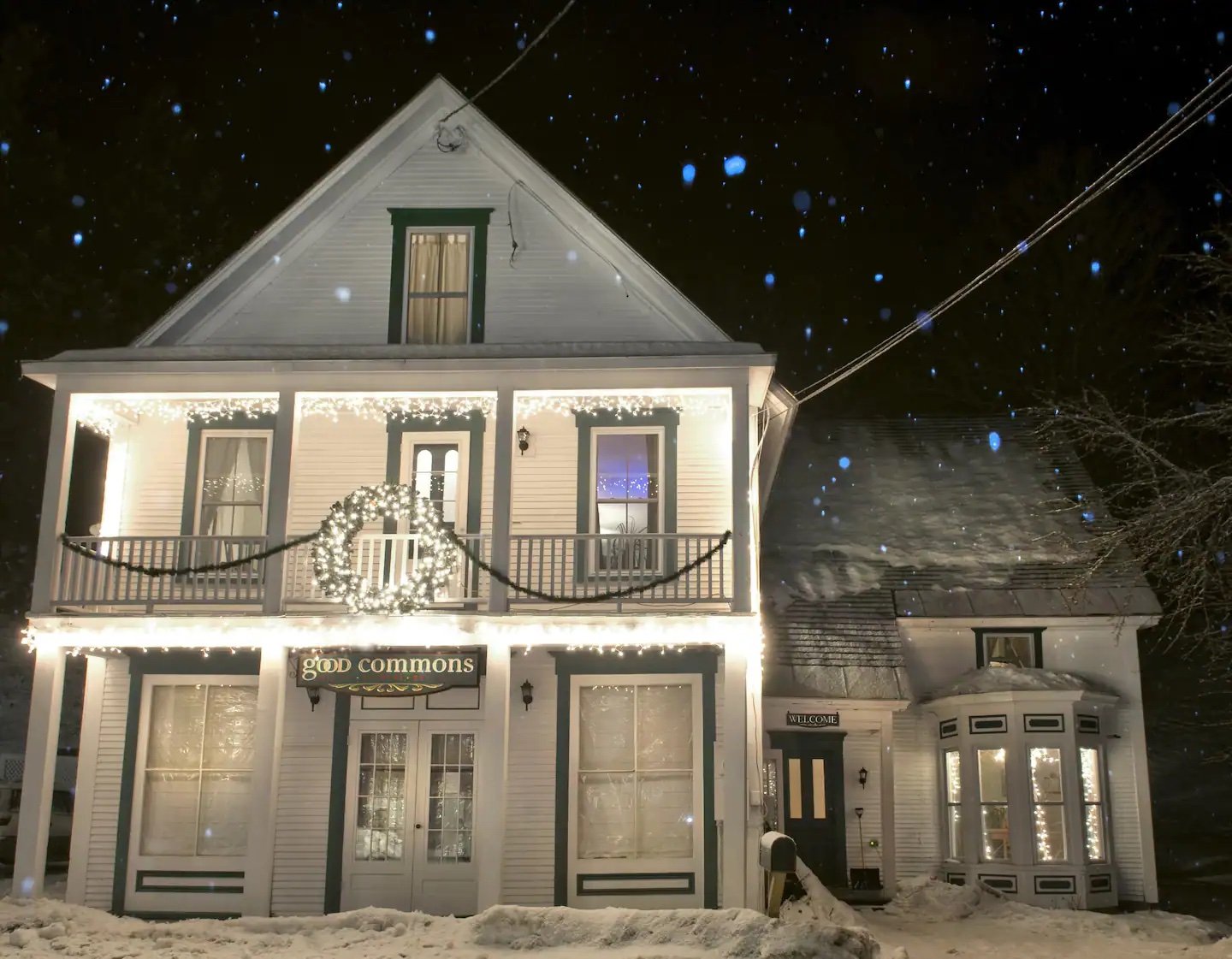 Good Commons exterior at night, snow-covered, warmly lit