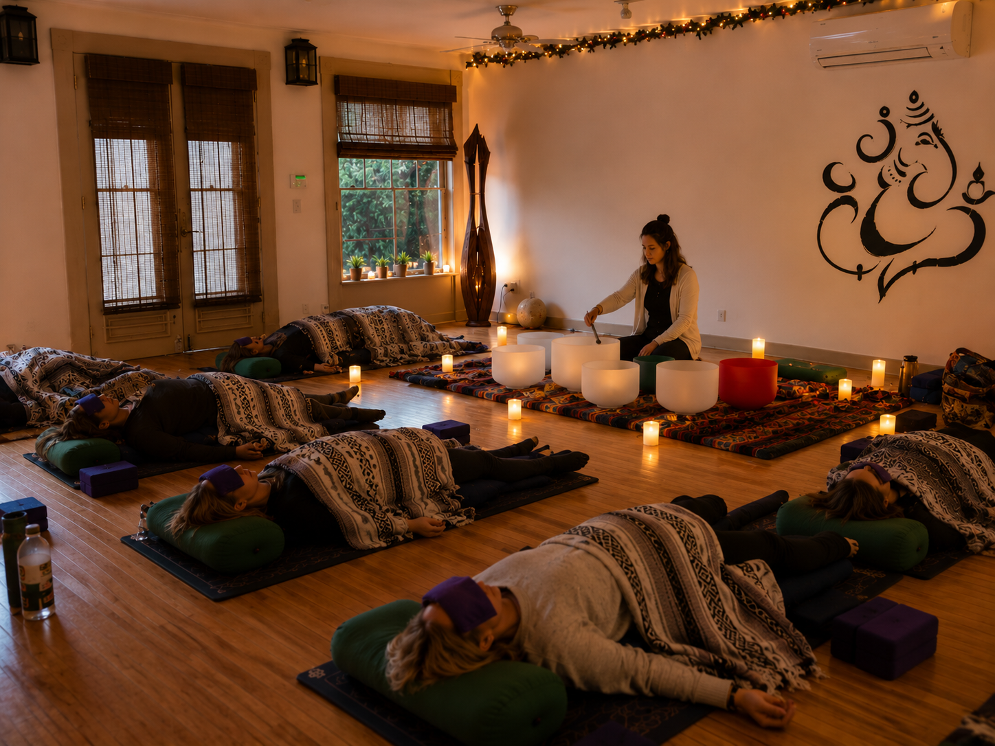 Sound healing ceremony at Good Commons — candlelight, singing bowls, women at rest