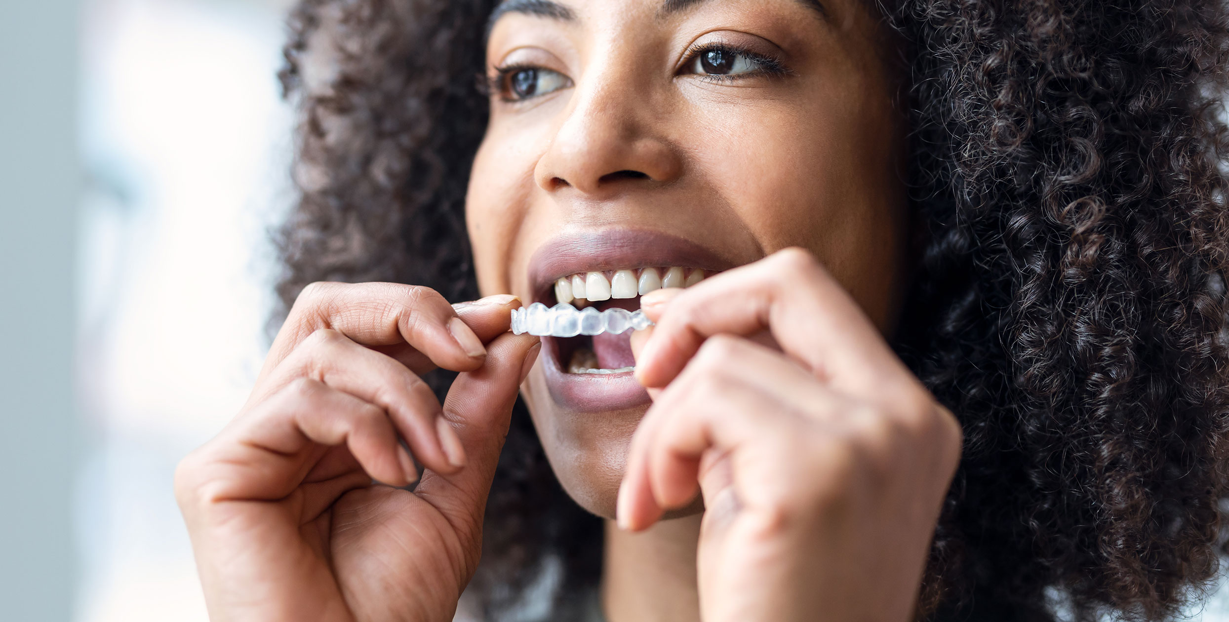 Woman holding invisalign