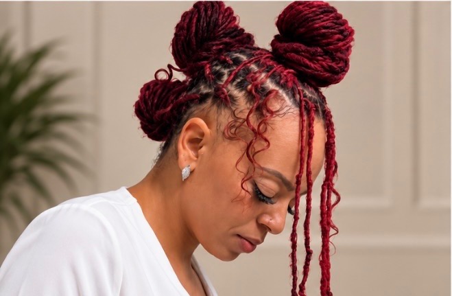Burgundy loc space buns with curly tendrils
