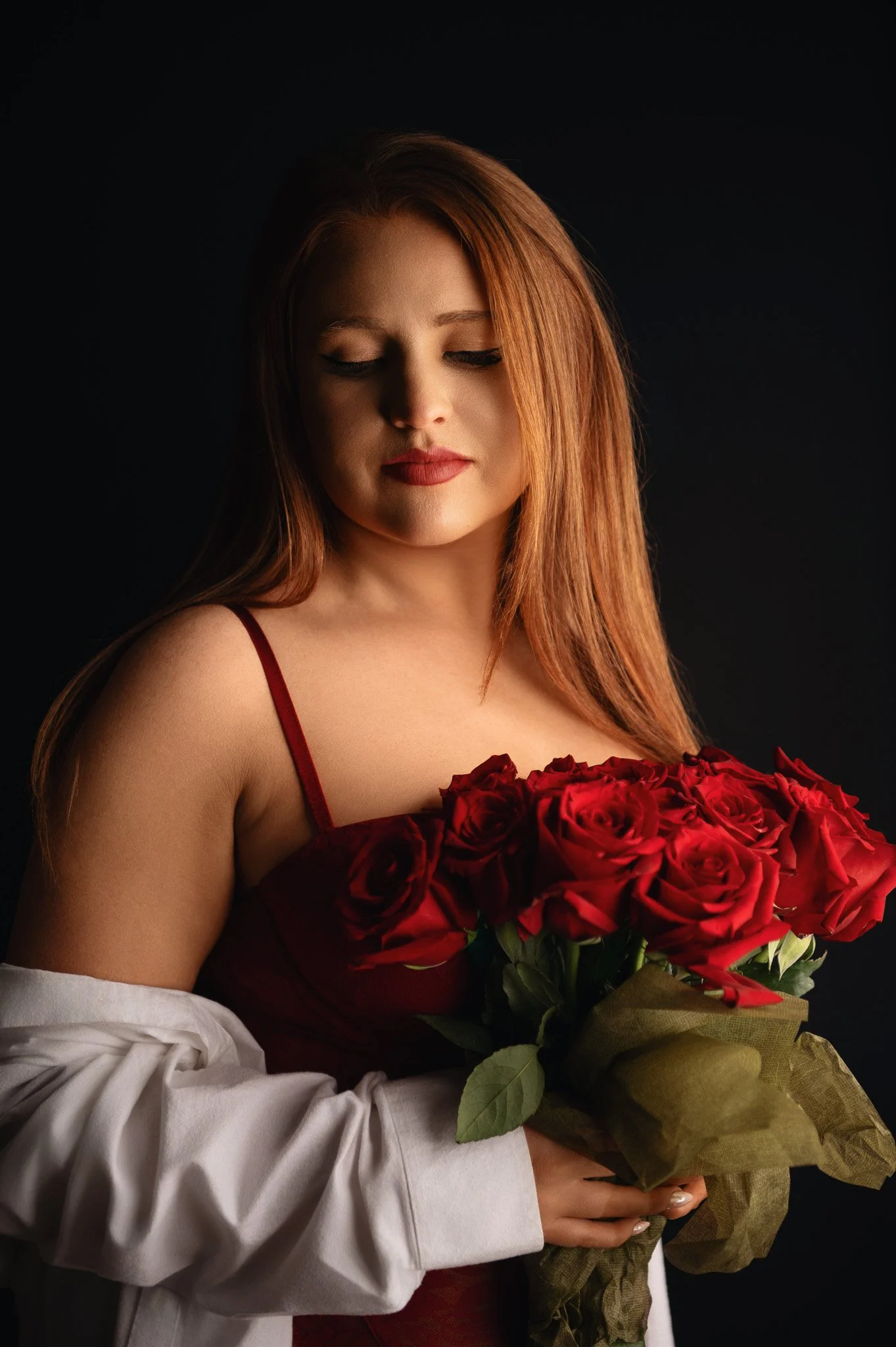 woman in red lingerie holding red roses