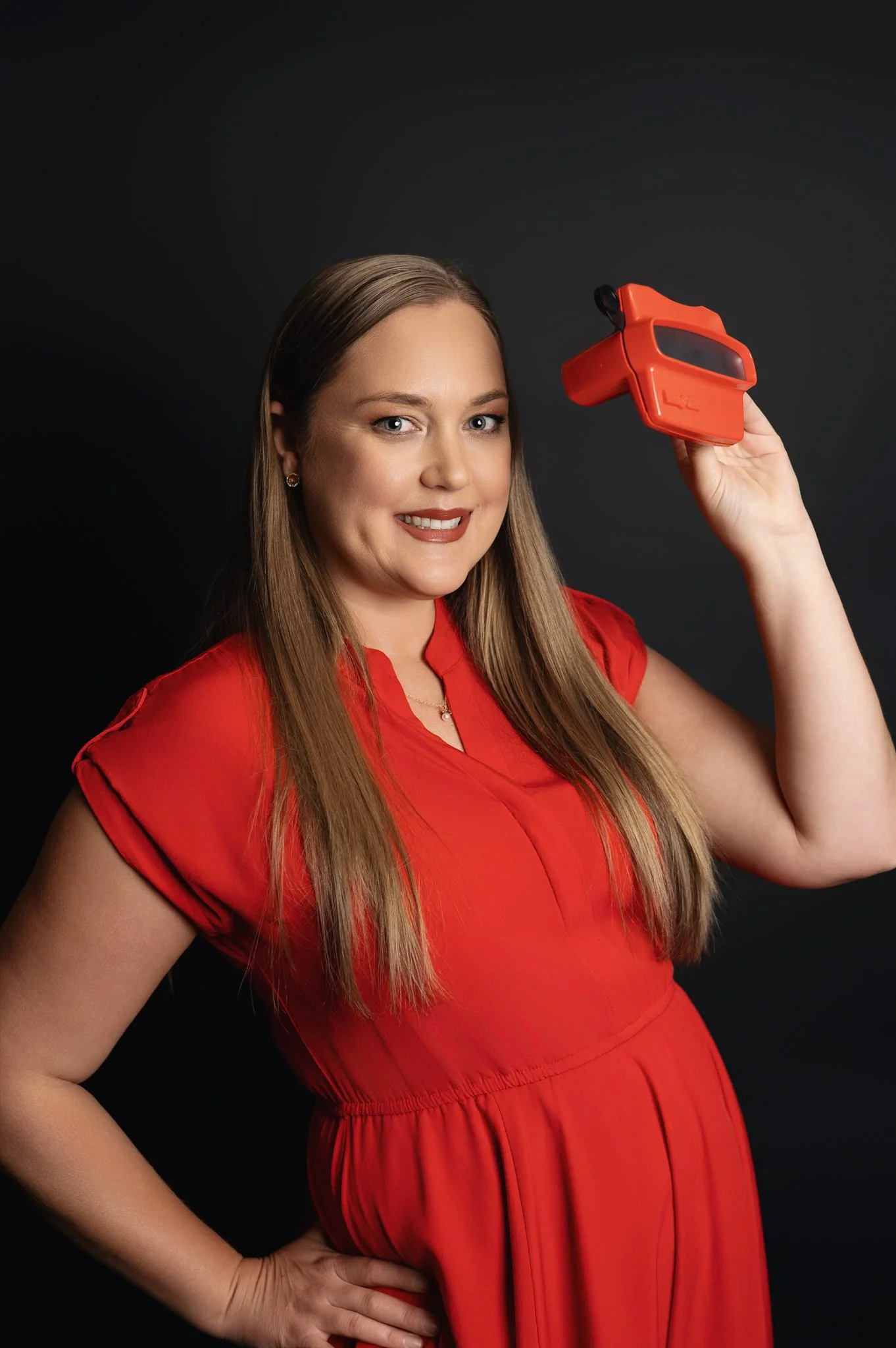 woman in red dress with viewfinder