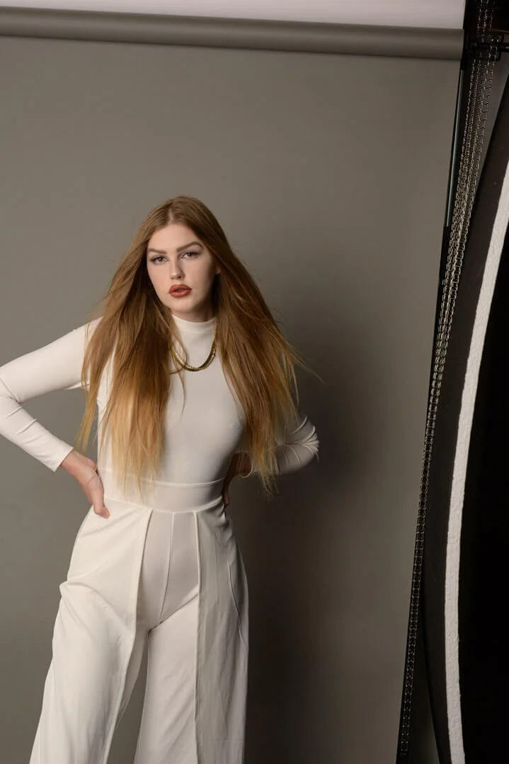 young woman in white jumpsuit