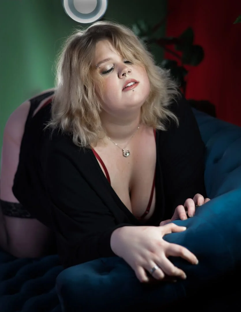 woman leaning over arm of sofa