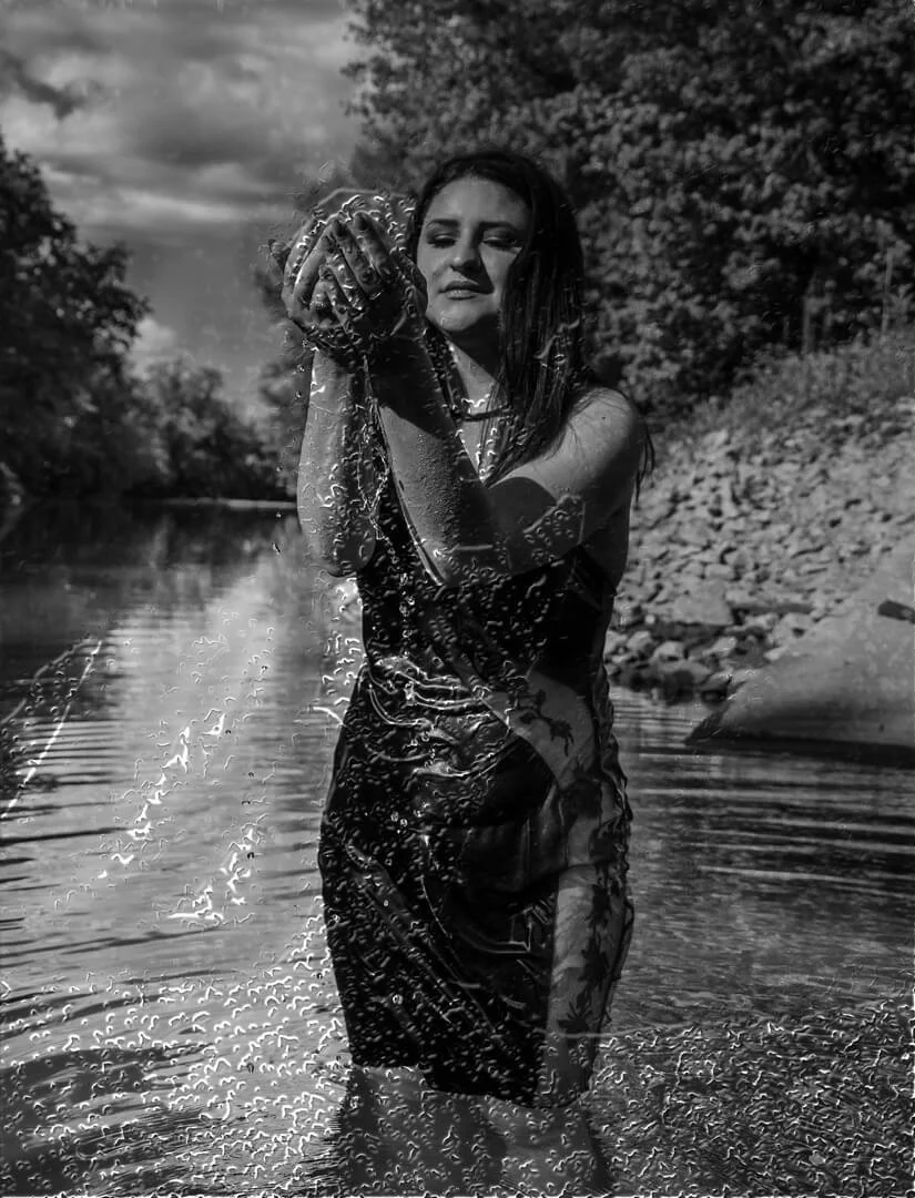 woman splashing water in a creek