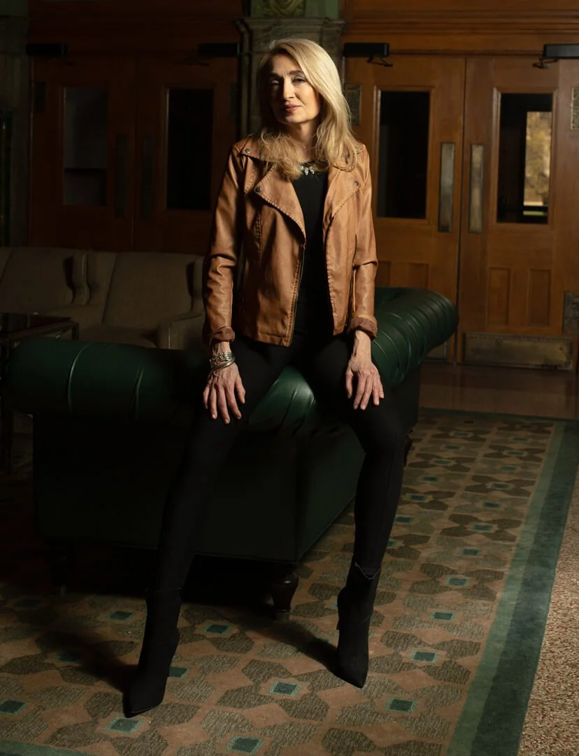 young woman sitting on edge of sofa